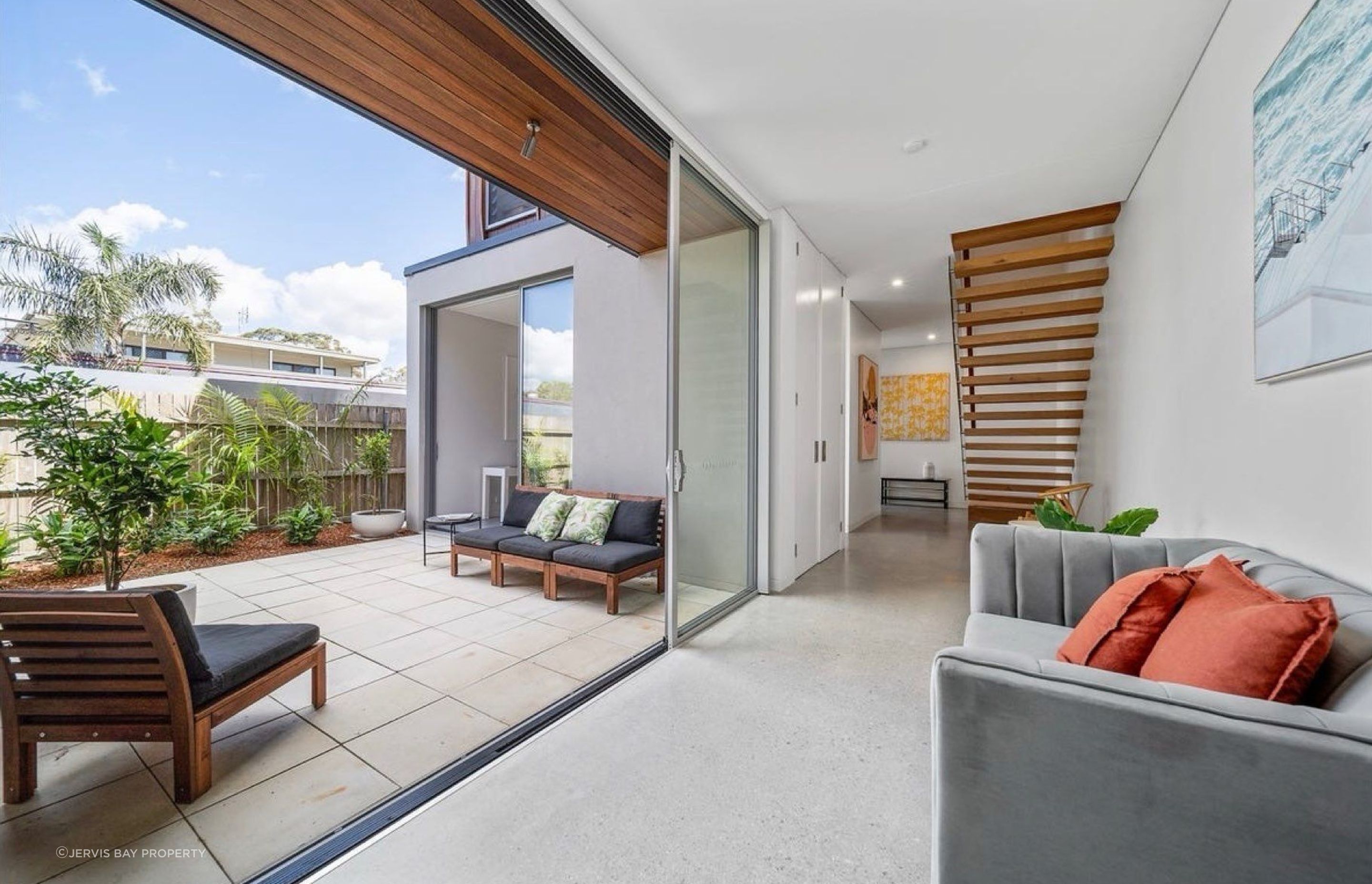 View to the front of the home with floating stairs
