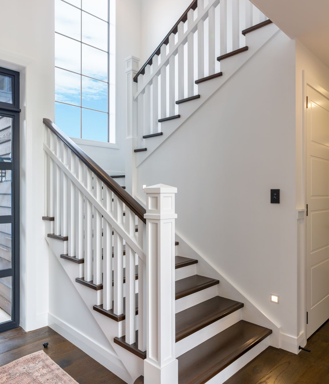 The stunning staircase with traditional newell post detail and oak treads is a beauty to behold, and fits in seamlessly with the engineered timber floors and character detailing.