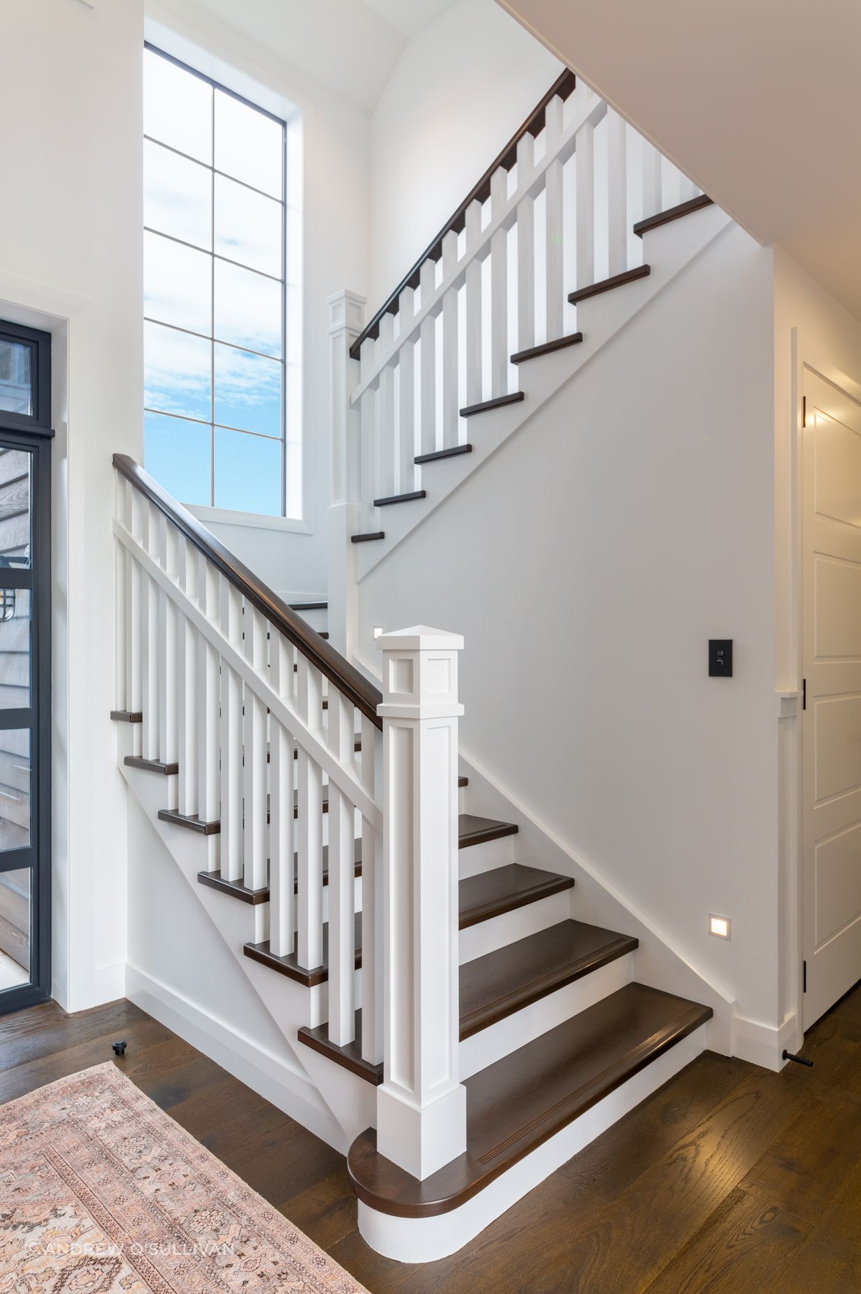 The stunning staircase with traditional newell post detail and oak treads is a beauty to behold, and fits in seamlessly with the engineered timber floors and character detailing.
