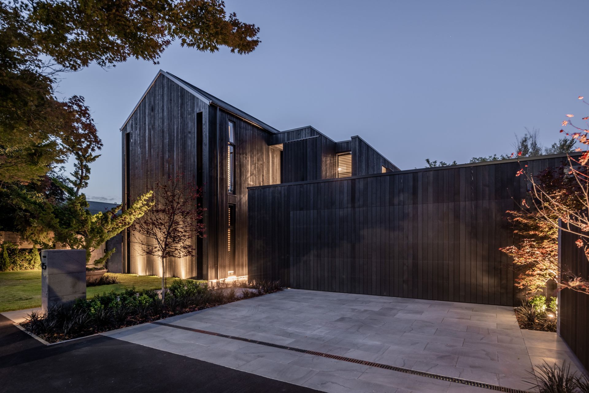 A dark exterior allows the Japanese maple trees and surrounding nature to be the focus.
