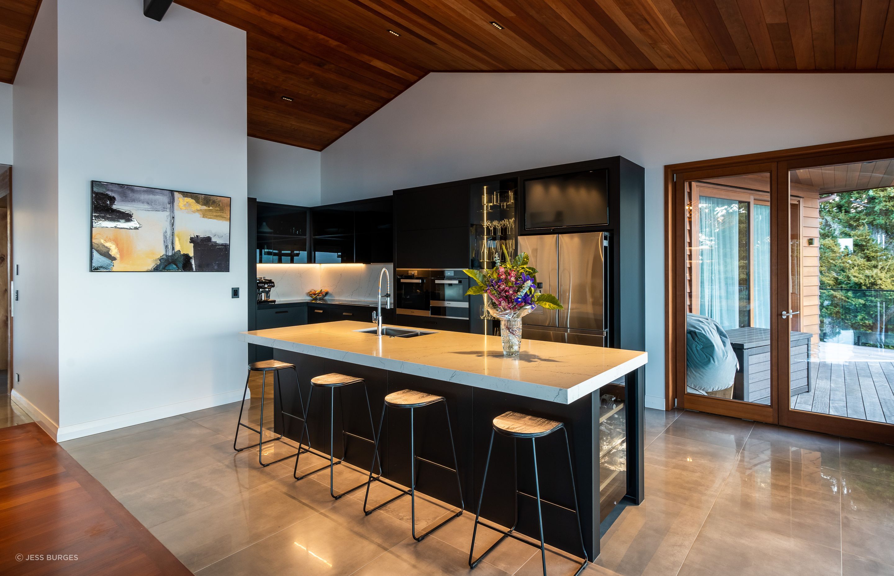 The ovens in the kitchen are by Miele and the fridge is by Samsung. With a glassware display cabinet, two dishwashers and a Vintec wine fridge, it's a house made for entertaining.