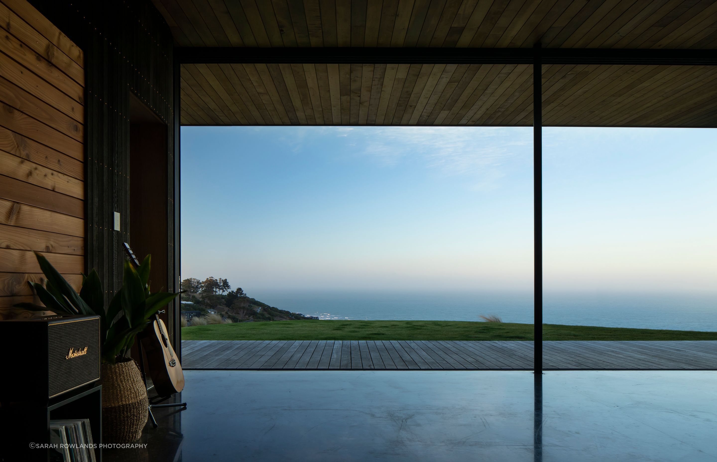A view of the sea, captured from the interior of the glass living pavilion.