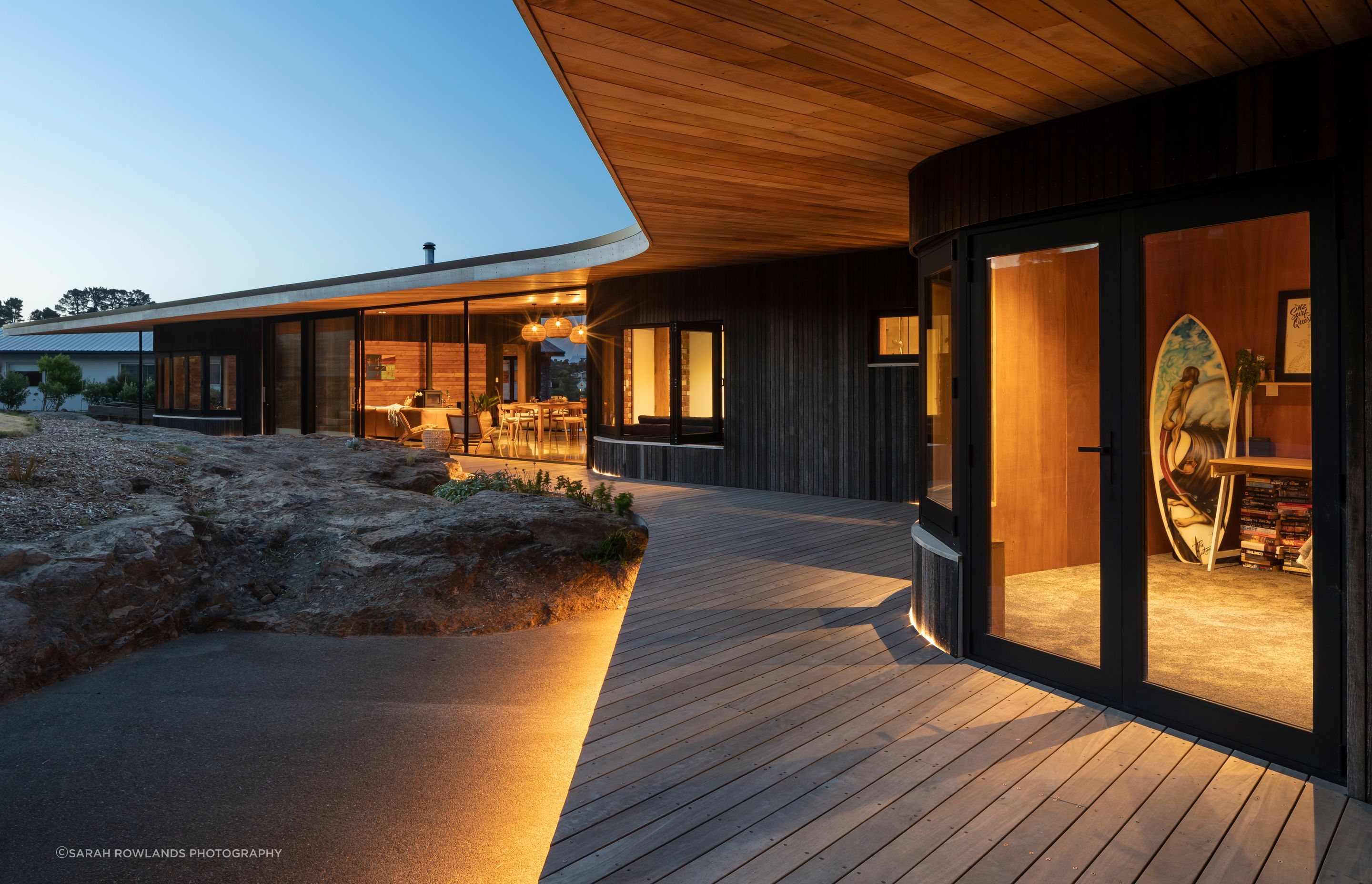 At the rear of the house, the deck is cut around the existing rock formations.