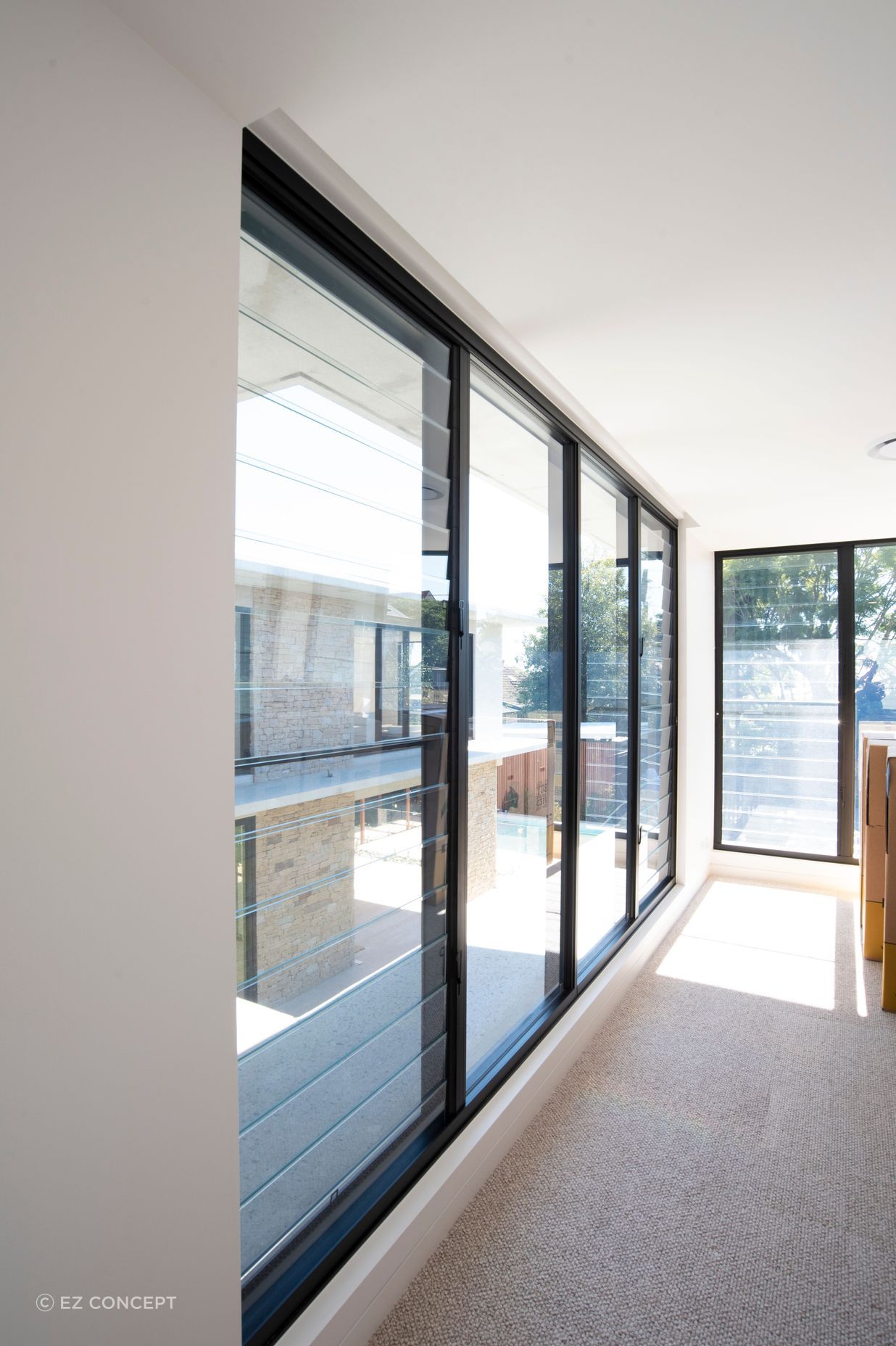 Eye-catching vistas of the backyard are opened up by the EzyPelmet recessed pelmet system installed alongside EzyReveal windows
