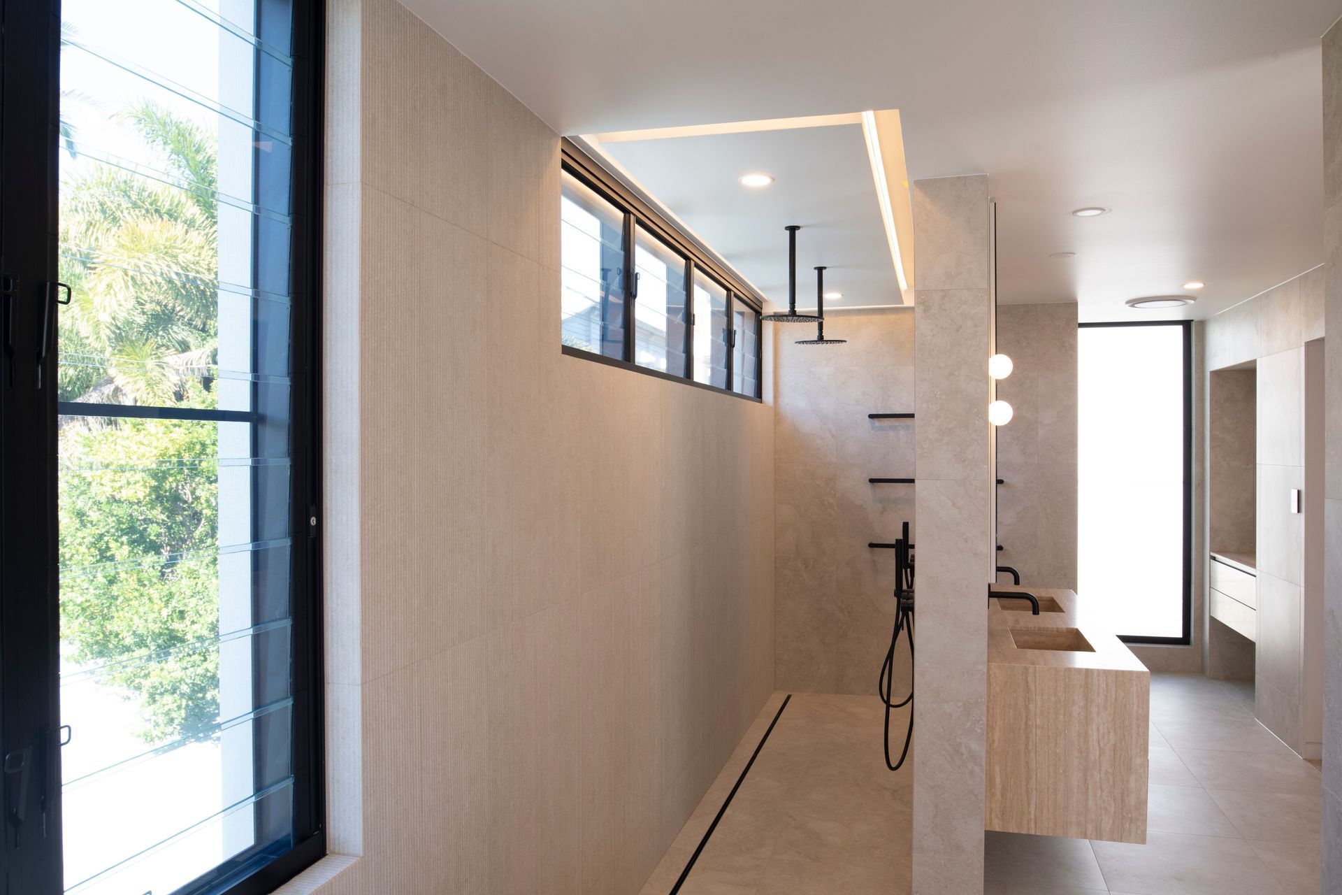 The downstairs bathroom and shower are defined by clean lines thanks to the striking openings created by the EzyReveal.