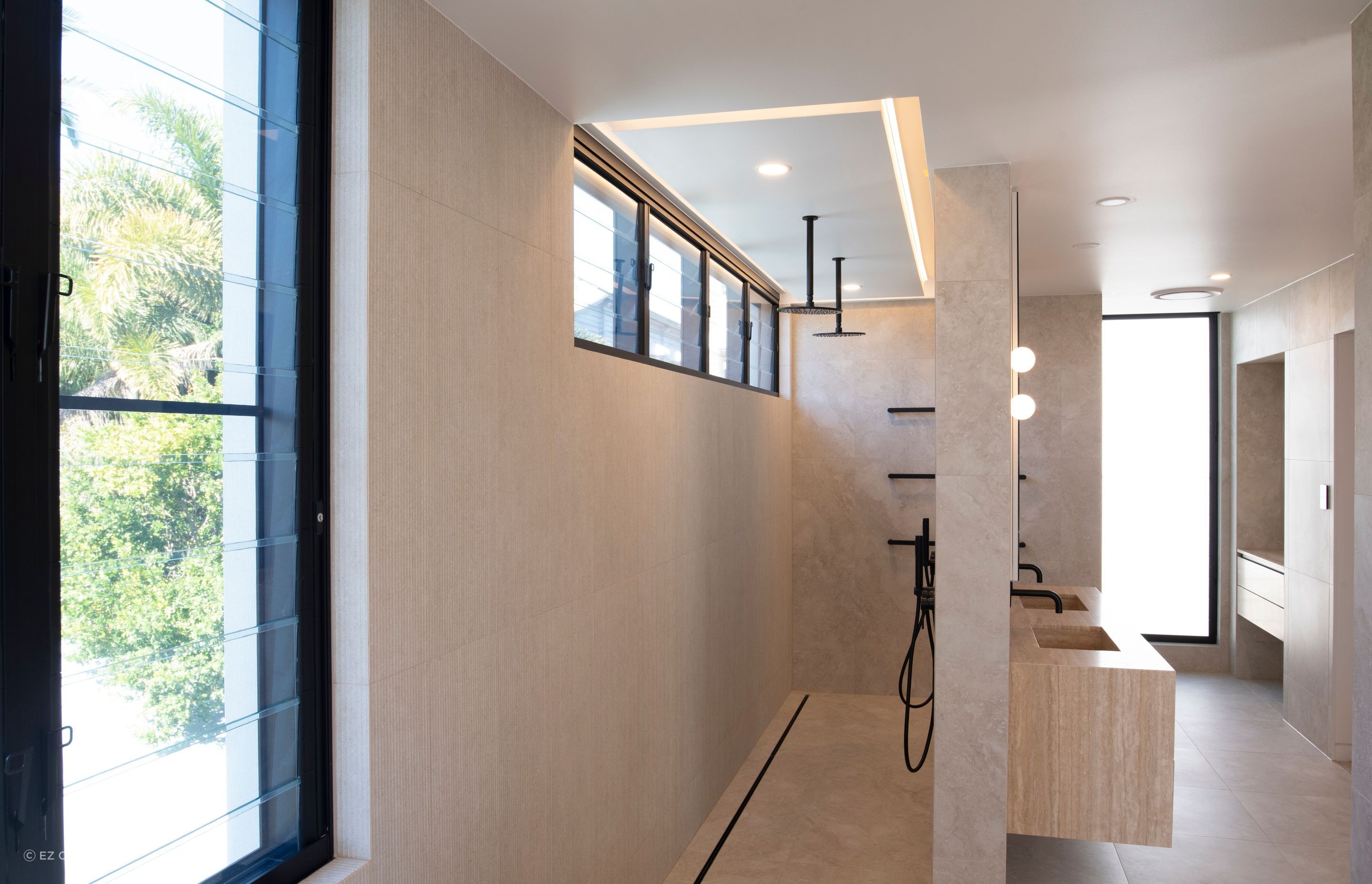 The downstairs bathroom and shower are defined by clean lines thanks to the striking openings created by the EzyReveal.