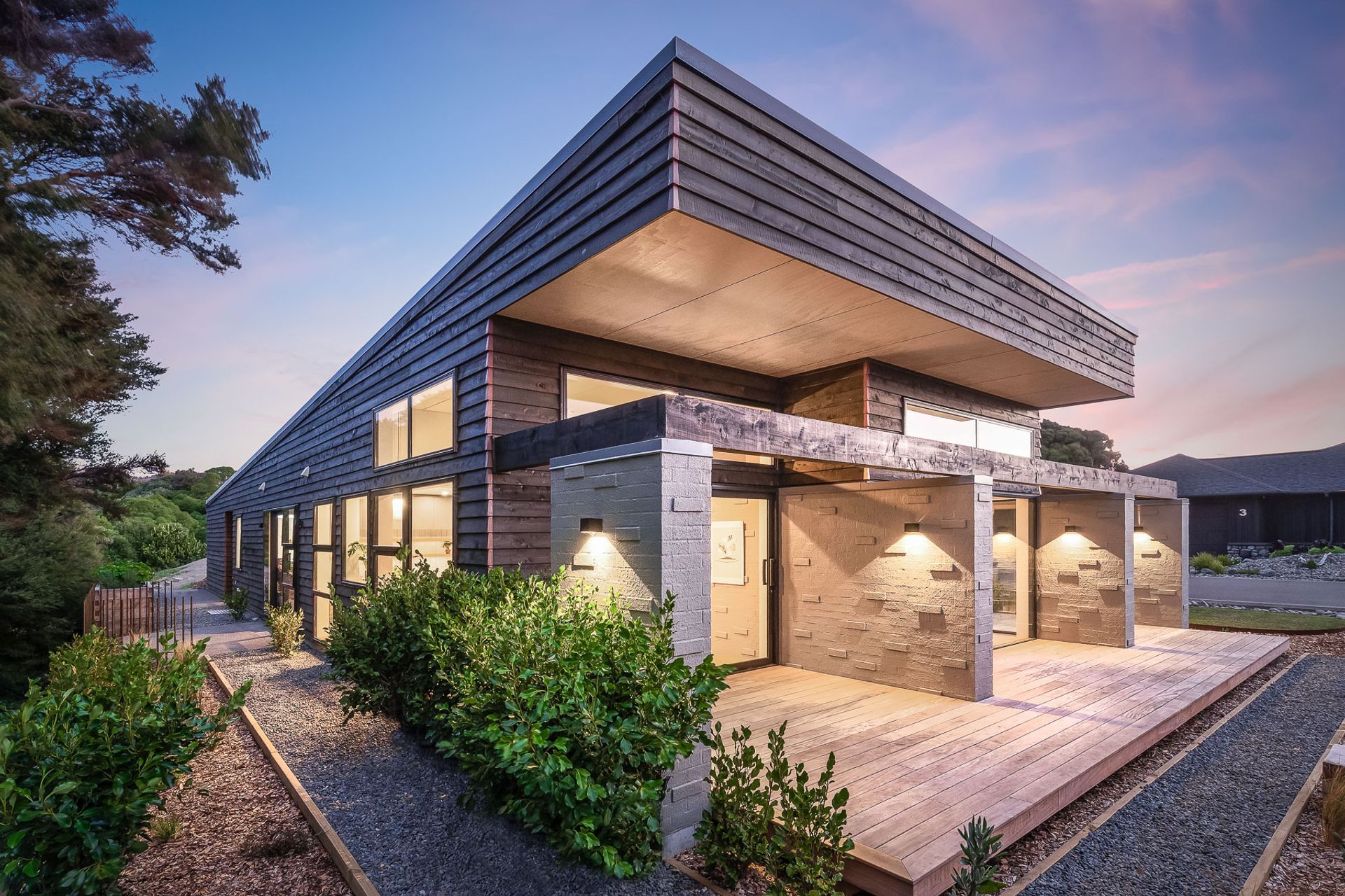 Locally sourced macrocarpa weatherboards have been teamed with bagged brickwork to give the home a very textural aesthetic, in keeping with its bush surroundings.