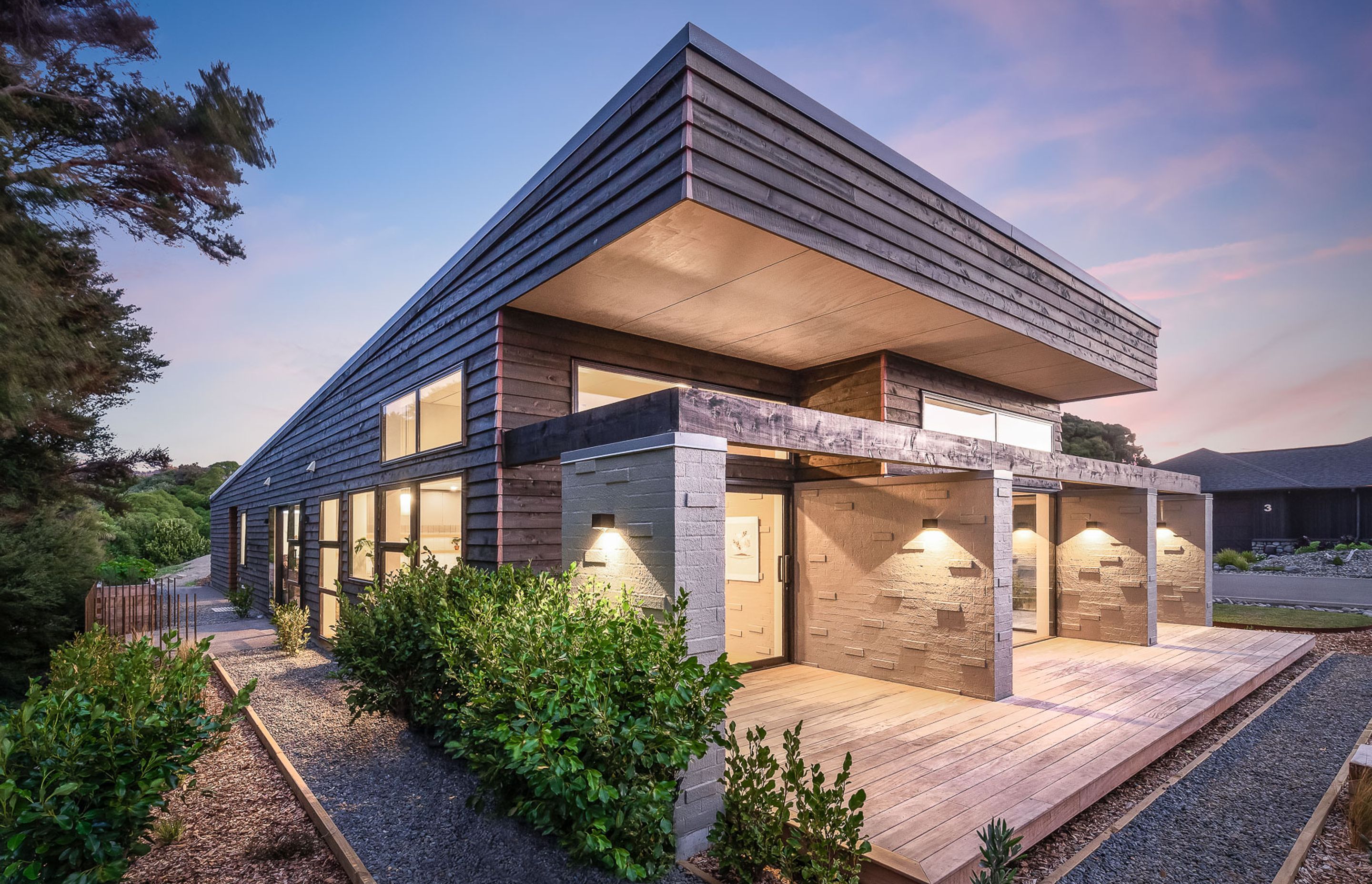 Locally sourced macrocarpa weatherboards have been teamed with bagged brickwork to give the home a very textural aesthetic, in keeping with its bush surroundings.