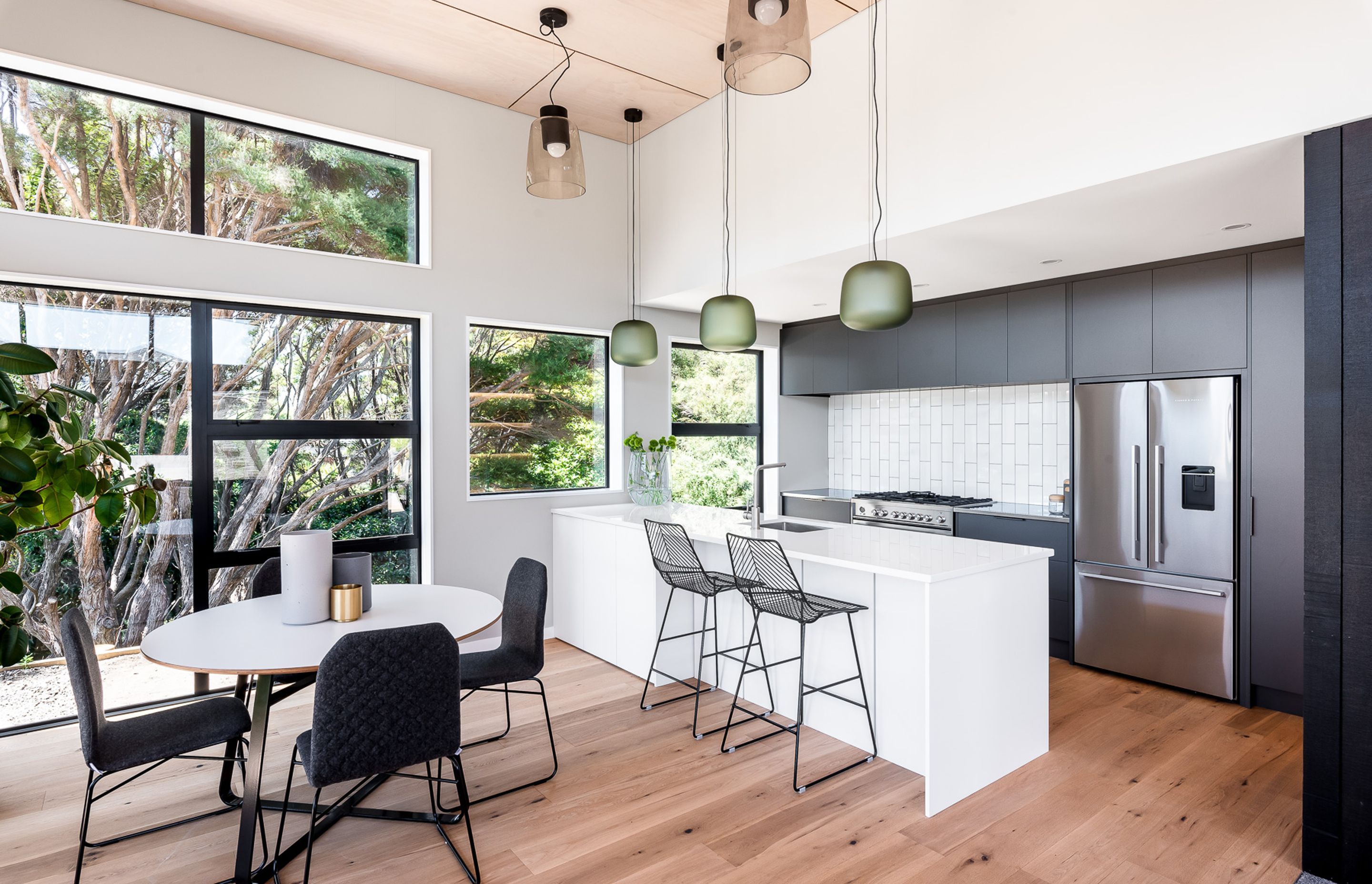 The custom kitchen incorporates soft-touch cabinetry, engineered stone and stainless-steel bench tops.