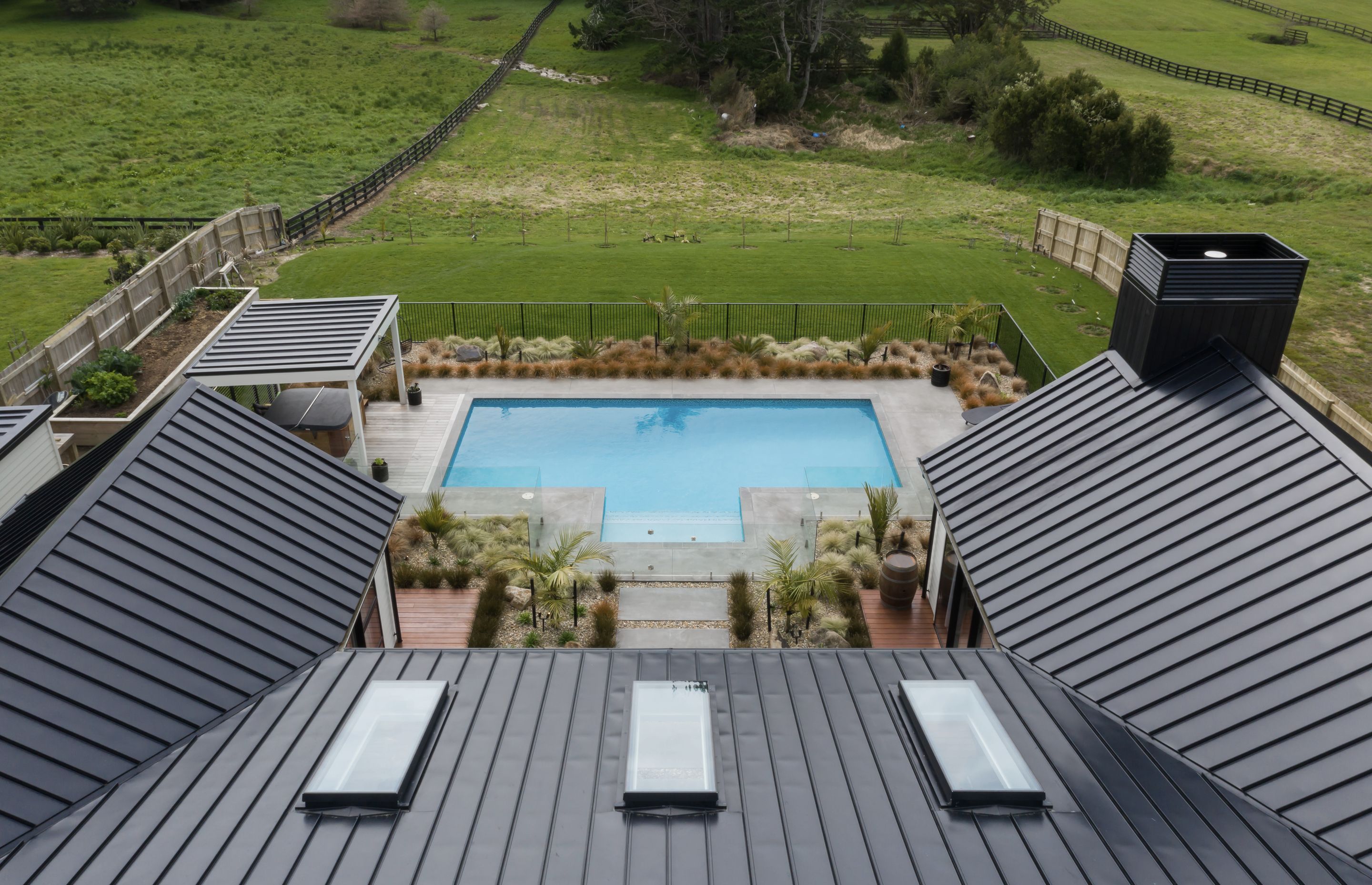 The bold lines of the Spanlok 380 pan ribbed roof by Roof Industries are a feature of the bold geometric home.