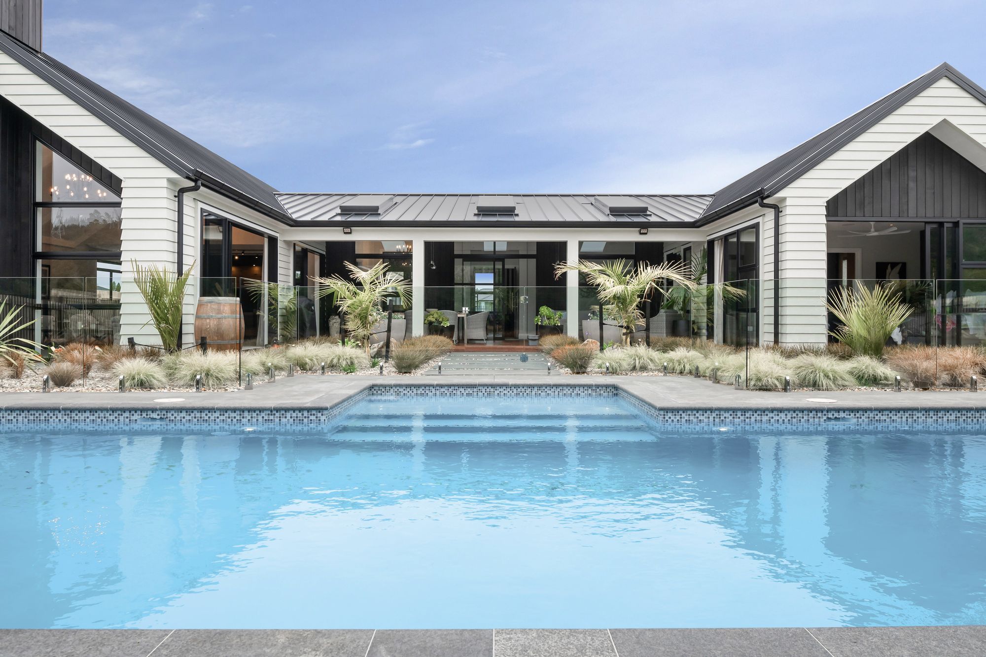 Outside, a covered veranda brightened by APL skylights from Vantage Windows sits privately sheltered within the three walls, looking out across the tranquil views.