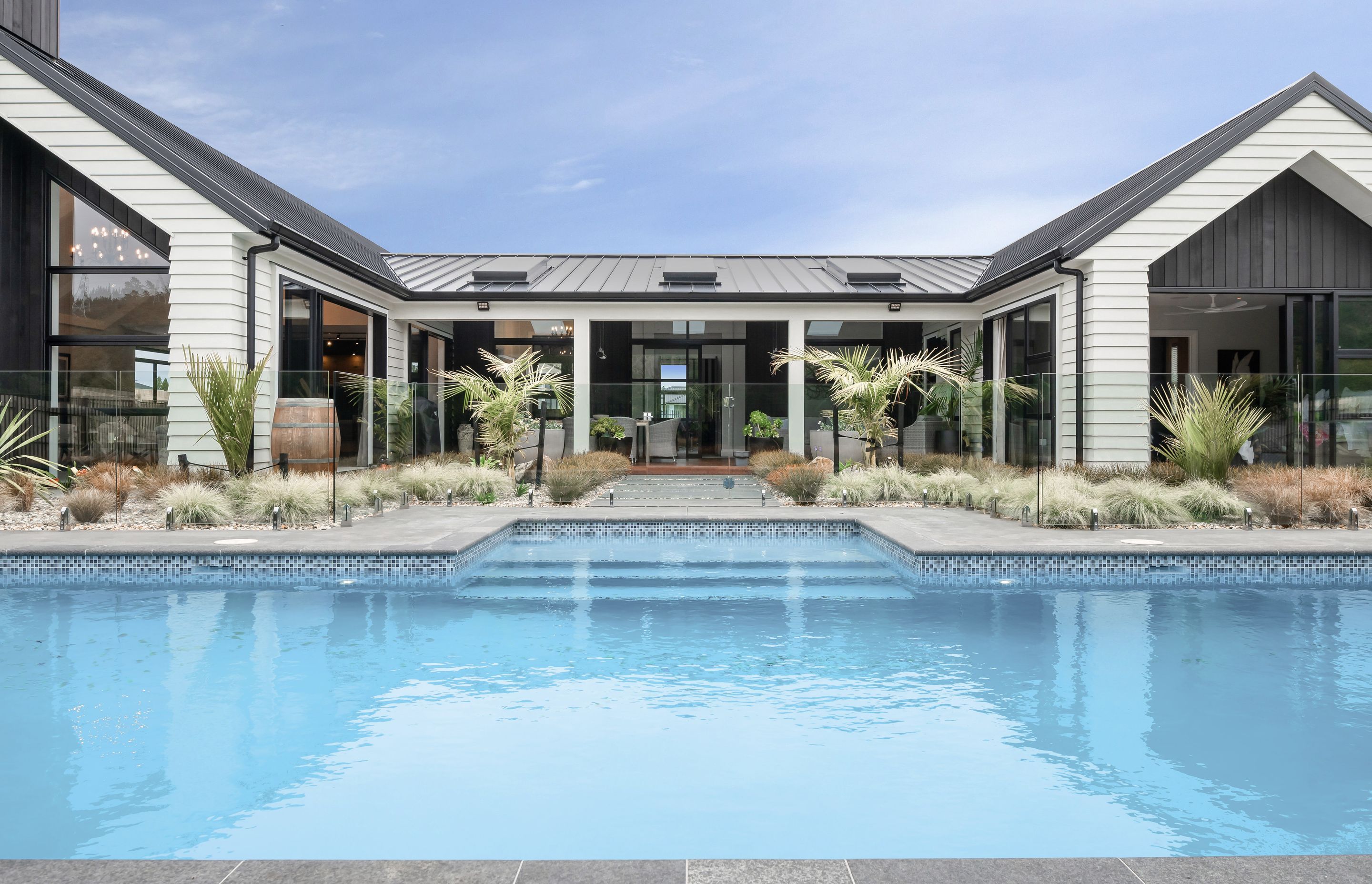  Outside, a covered veranda brightened by APL skylights from Vantage Windows sits privately sheltered within the three walls, looking out across the tranquil views.