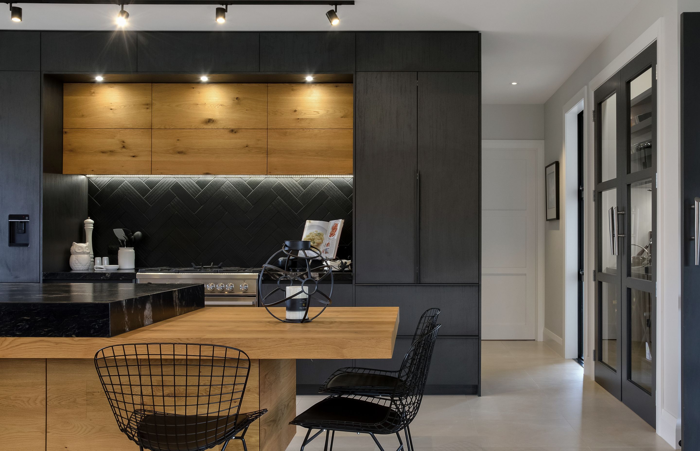 Rich timbers provide a striking and luxurious contrast to the stone benchtop.