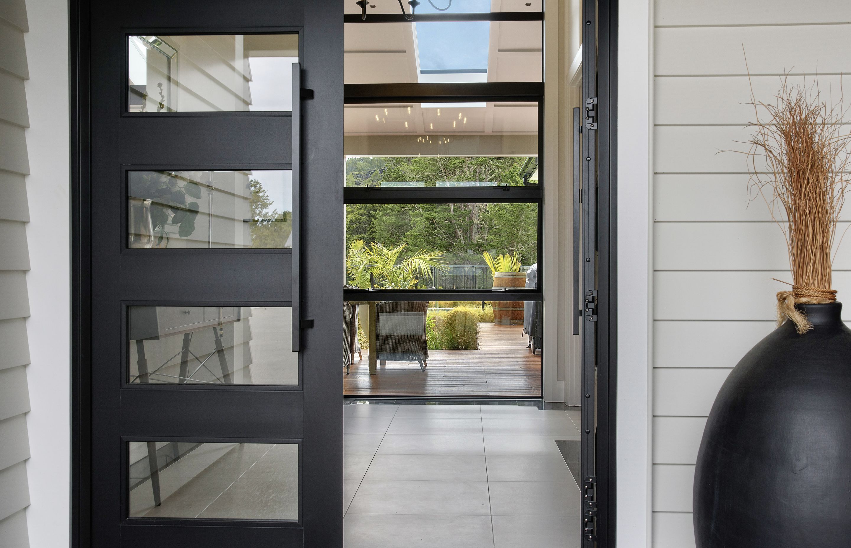 The glass front door and glass panels in the hallway allow the bush views to meet the visitors eye, before stepping into the house.