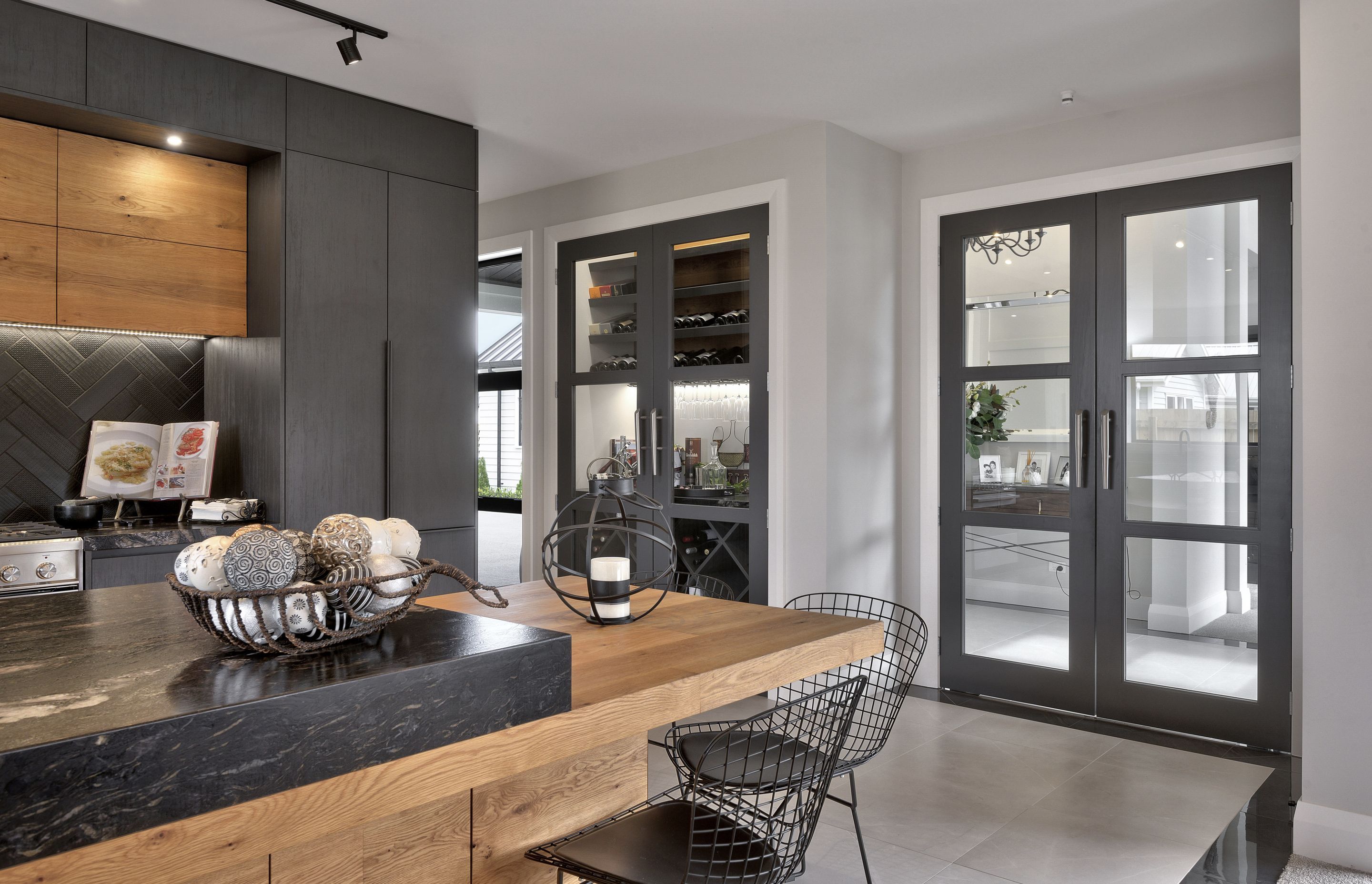 Meticulous finishes and exquisite detailing throughout add further opulence, such as the stunning kitchen, where the dark granite and cabinet doors contrast strikingly with the rich warmth of wood.