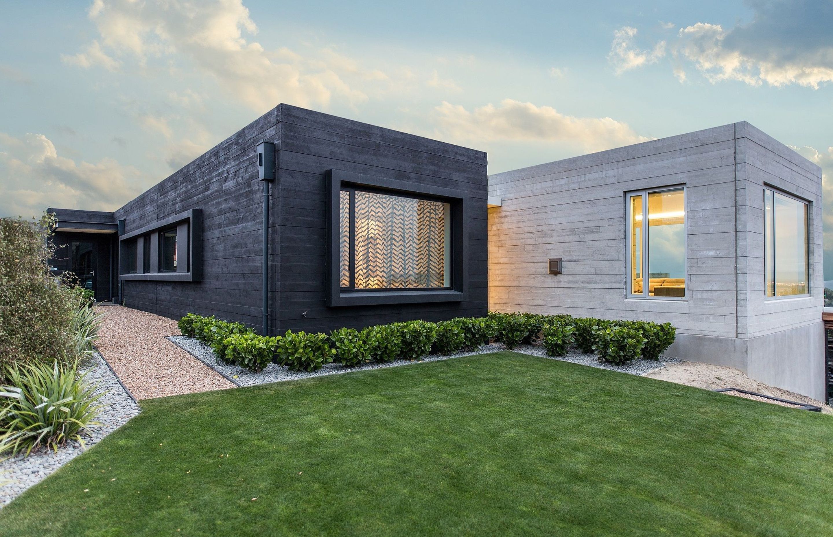 A black, timber stain was used on the exterior of the 'private' pavilion to provide contrast with the 'public' one. Similarly, an expressed window treatment on the one balances the recessed treatment of the other.