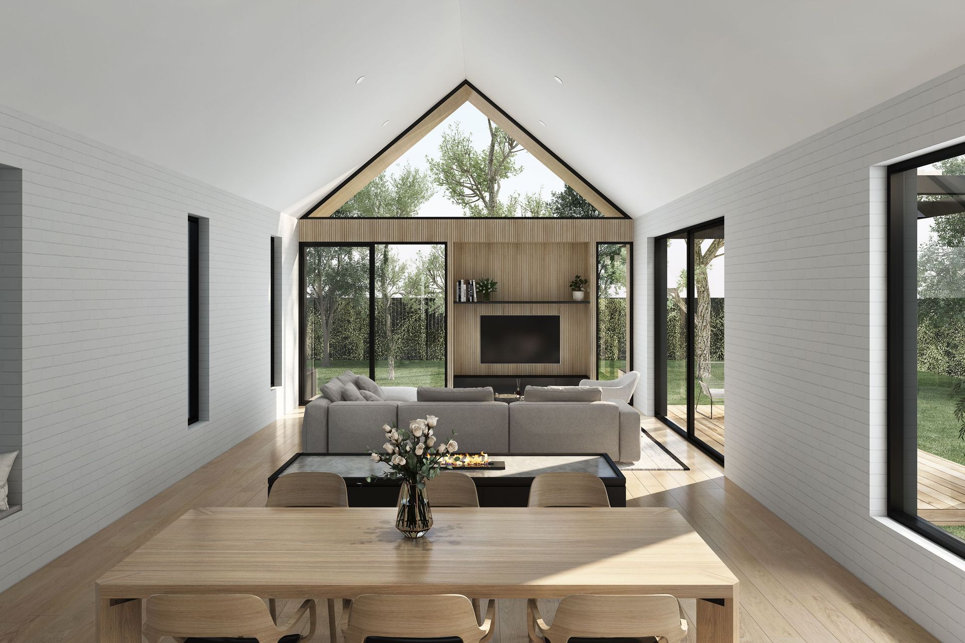 A cavernous, pitched ceiling opens up the central living area, with a neutral material palette of painted white brick and timber used throughout.