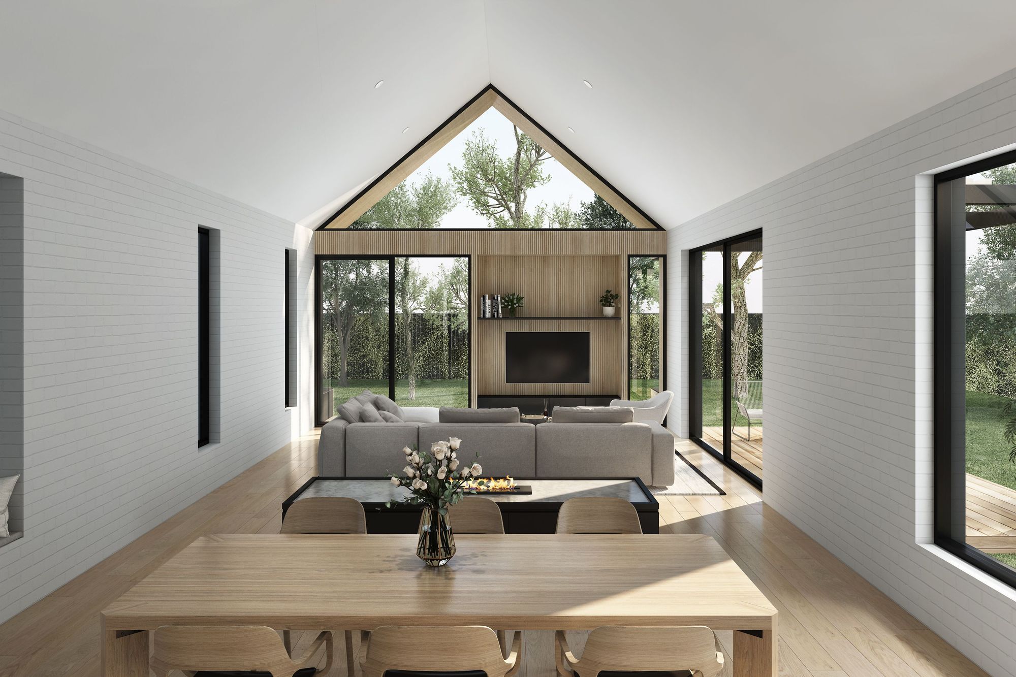 A cavernous, pitched ceiling opens up the central living area, with a neutral material palette of painted white brick and timber used throughout.