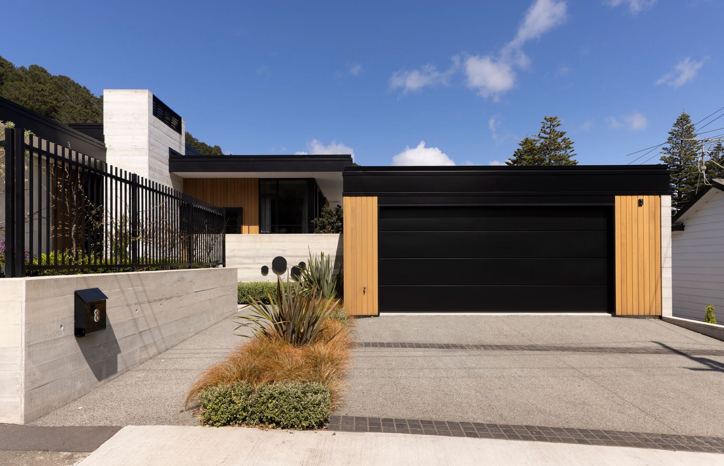 The three-bedroom home in Wellington’s Eastbourne is predominantly formed-concrete and cedar, says Richard Beatson of Studio Pacific Architecture. “The material palette is deliberately limited to maintain clarity in the design. It’s a contemporary interpretation of a mid-century style in scale, form and materiality.”