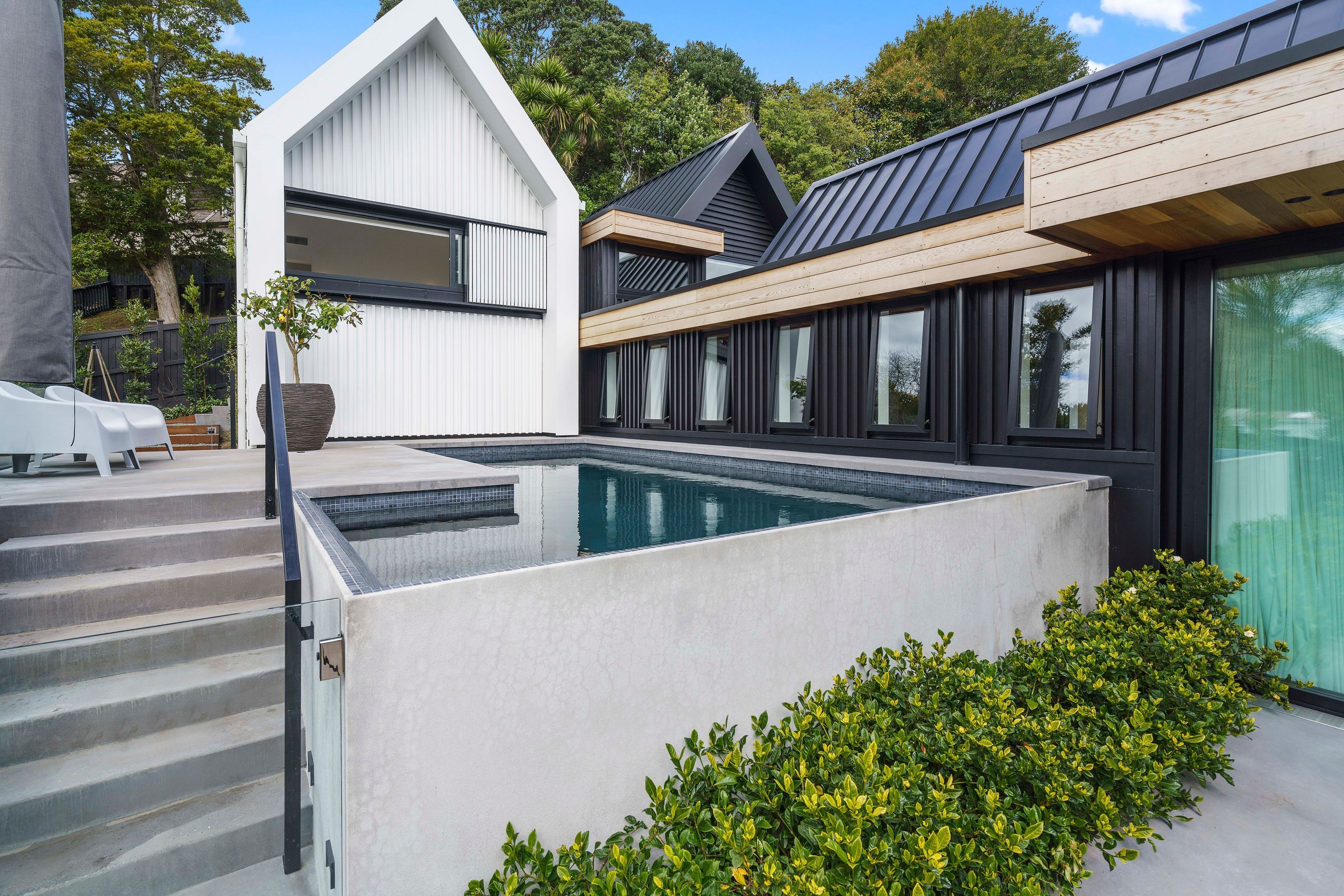 A clever use of space has allowed for the inclusion of a custom concrete swimming pool.