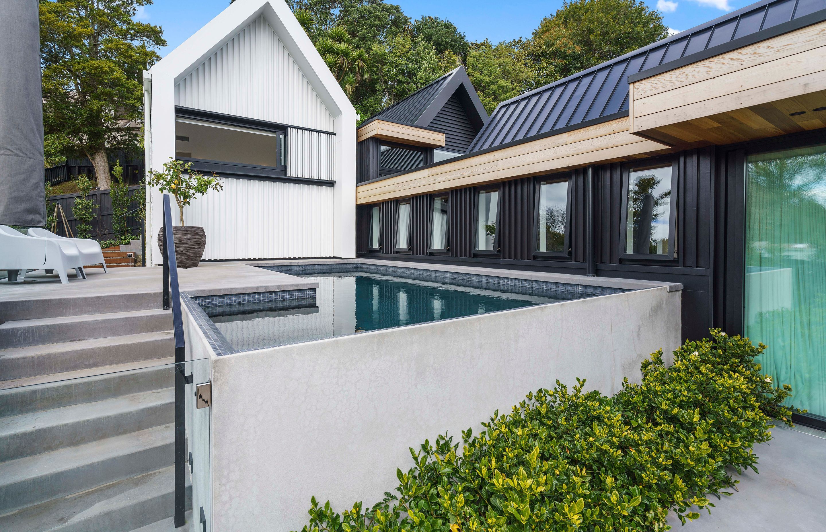 A clever use of space has allowed for the inclusion of a custom concrete swimming pool.