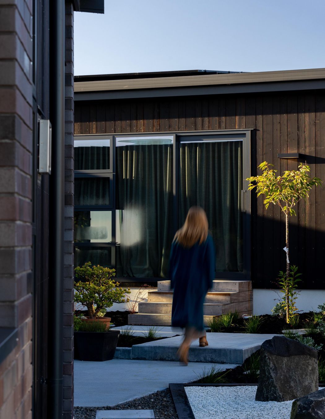 Internal courtyards to bedrooms, with dark cedar and brick exteriors