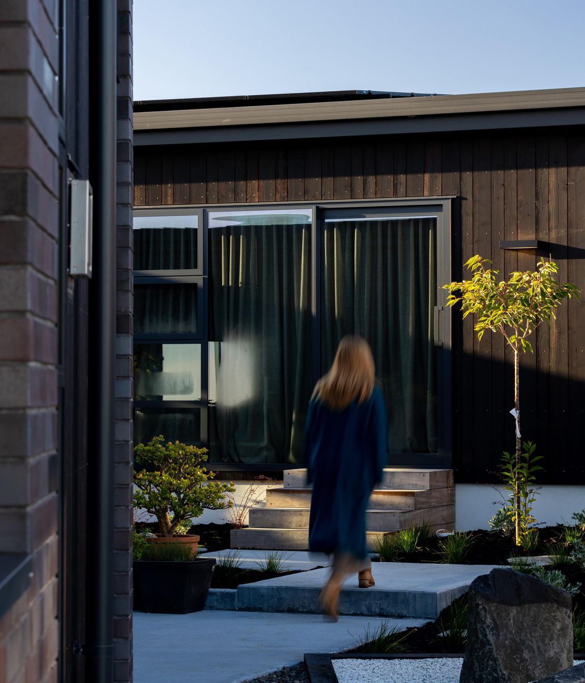 Internal courtyards to bedrooms, with dark cedar and brick exteriors