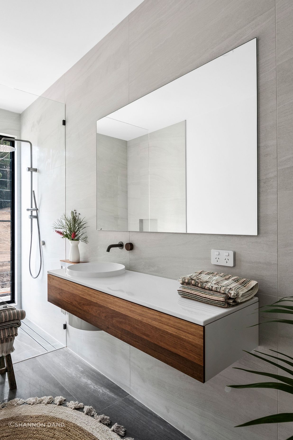 Raw and natural material finishes in the ground floor bathroom.
