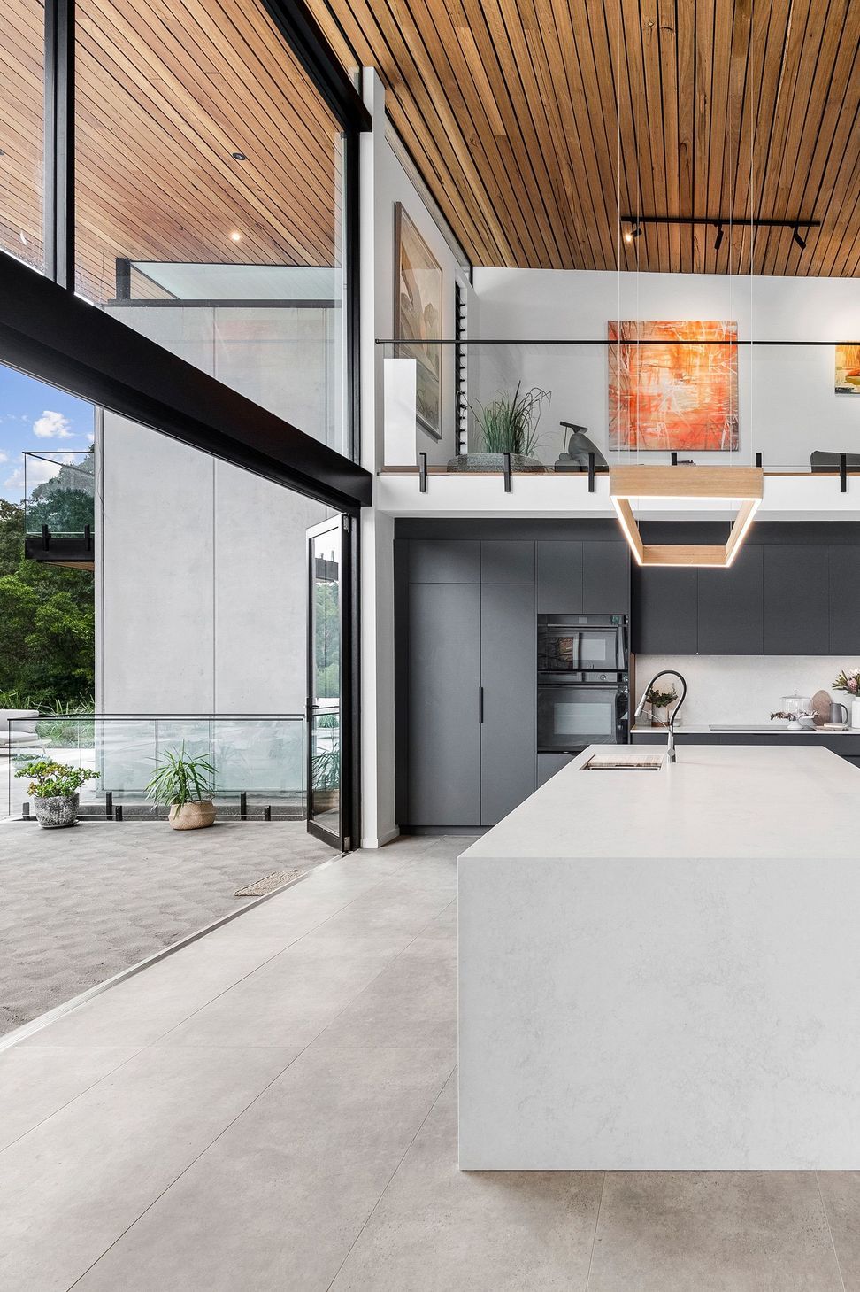 Soft language between interior and exterior. View of kitchen opening onto the verandah.