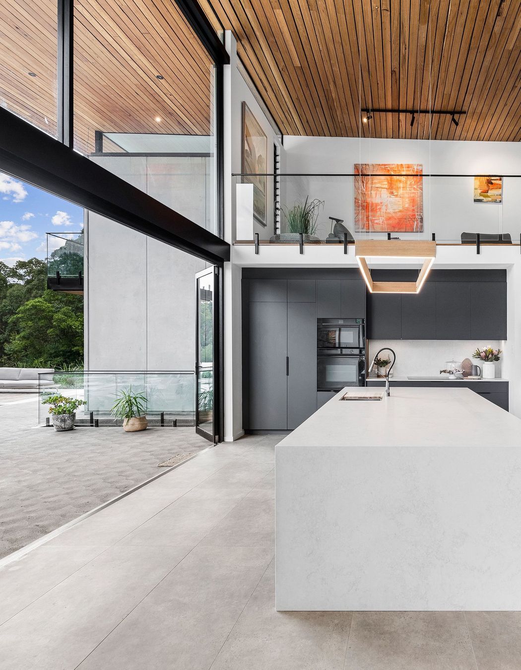 Soft language between interior and exterior. View of kitchen opening onto the verandah.