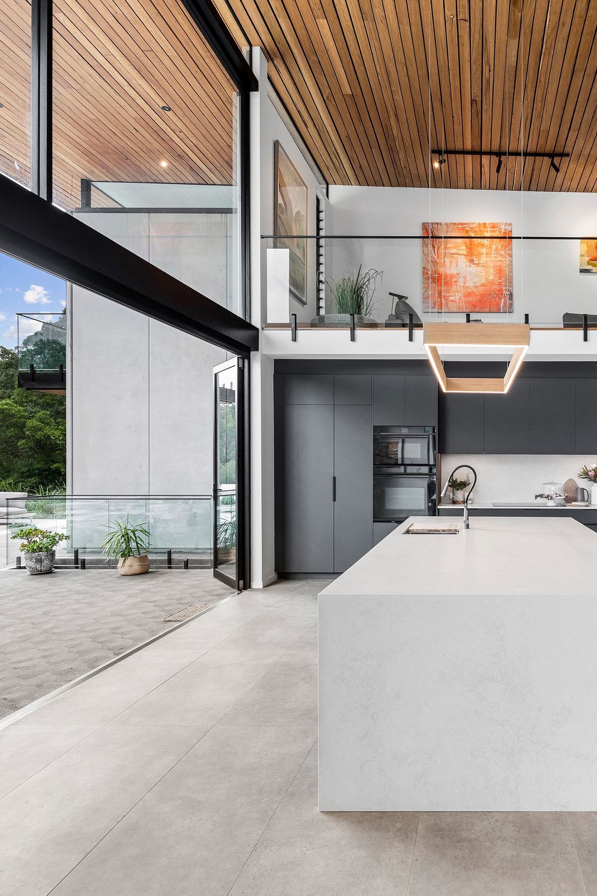 Soft language between interior and exterior. View of kitchen opening onto the verandah.
