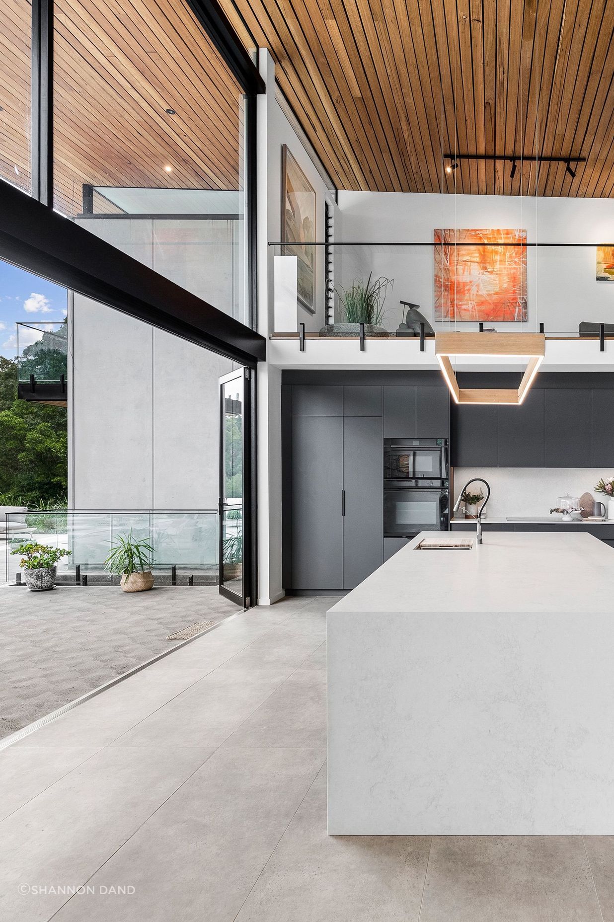 Soft language between interior and exterior. View of kitchen opening onto the verandah.