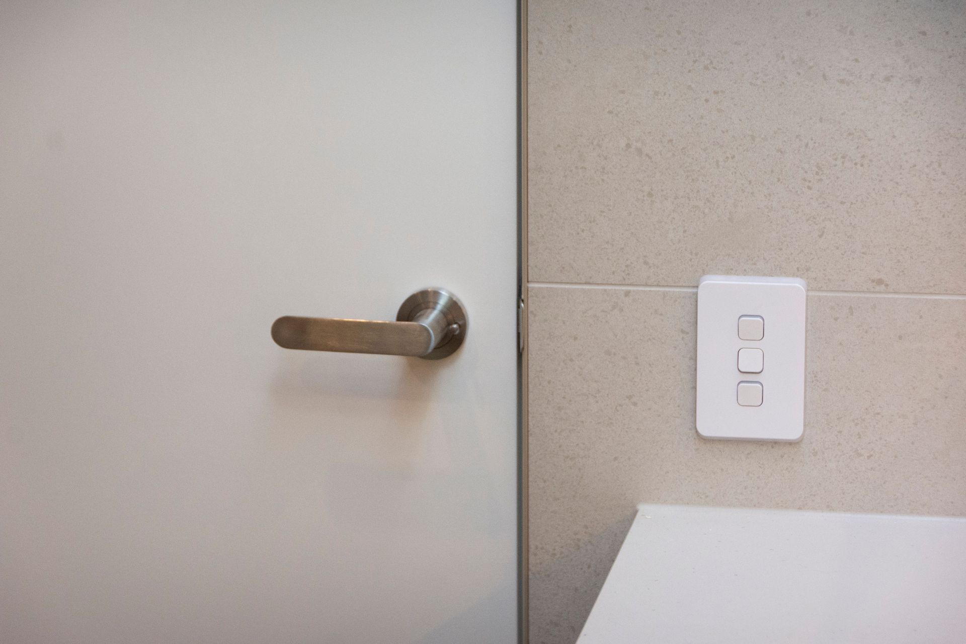 Stainless Steel RocYork Lift Off Hinges installed in the bathroom door opening.