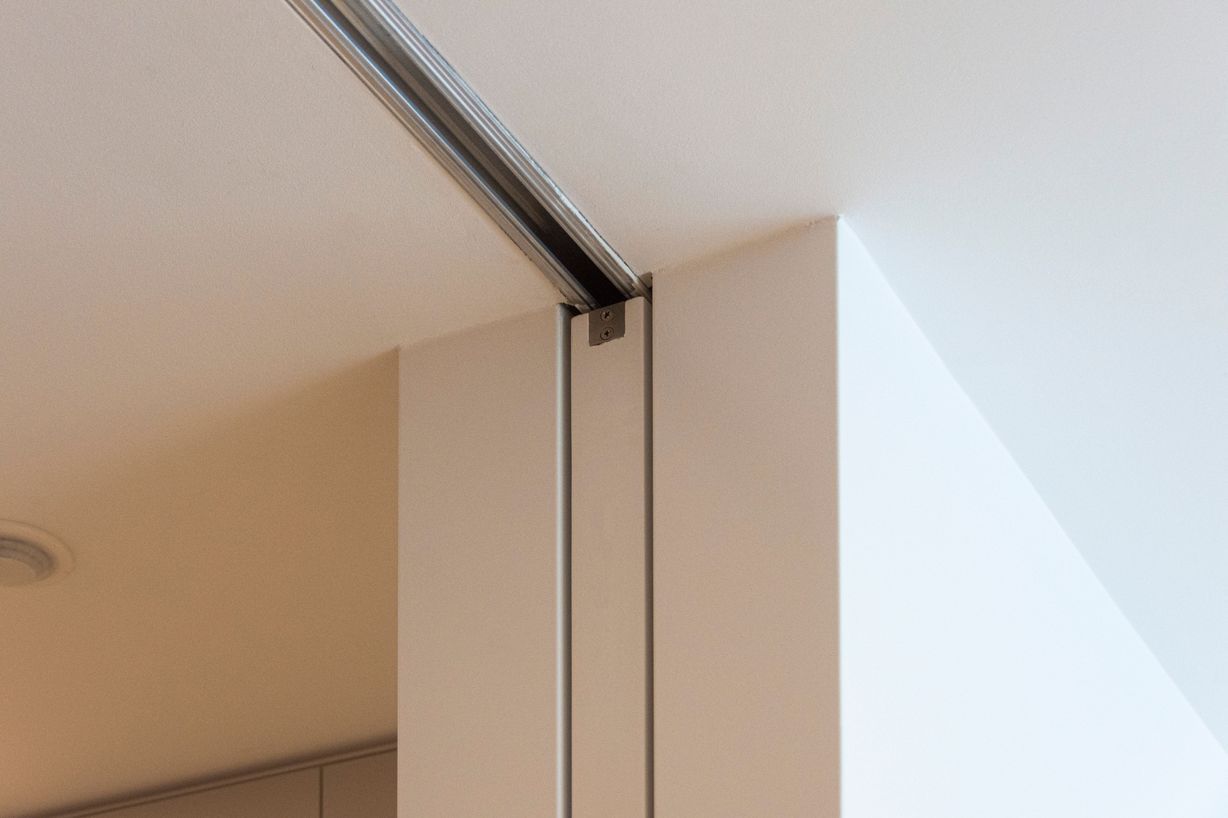 A flush finish cavity slider completely receding into the wall end whilst open.