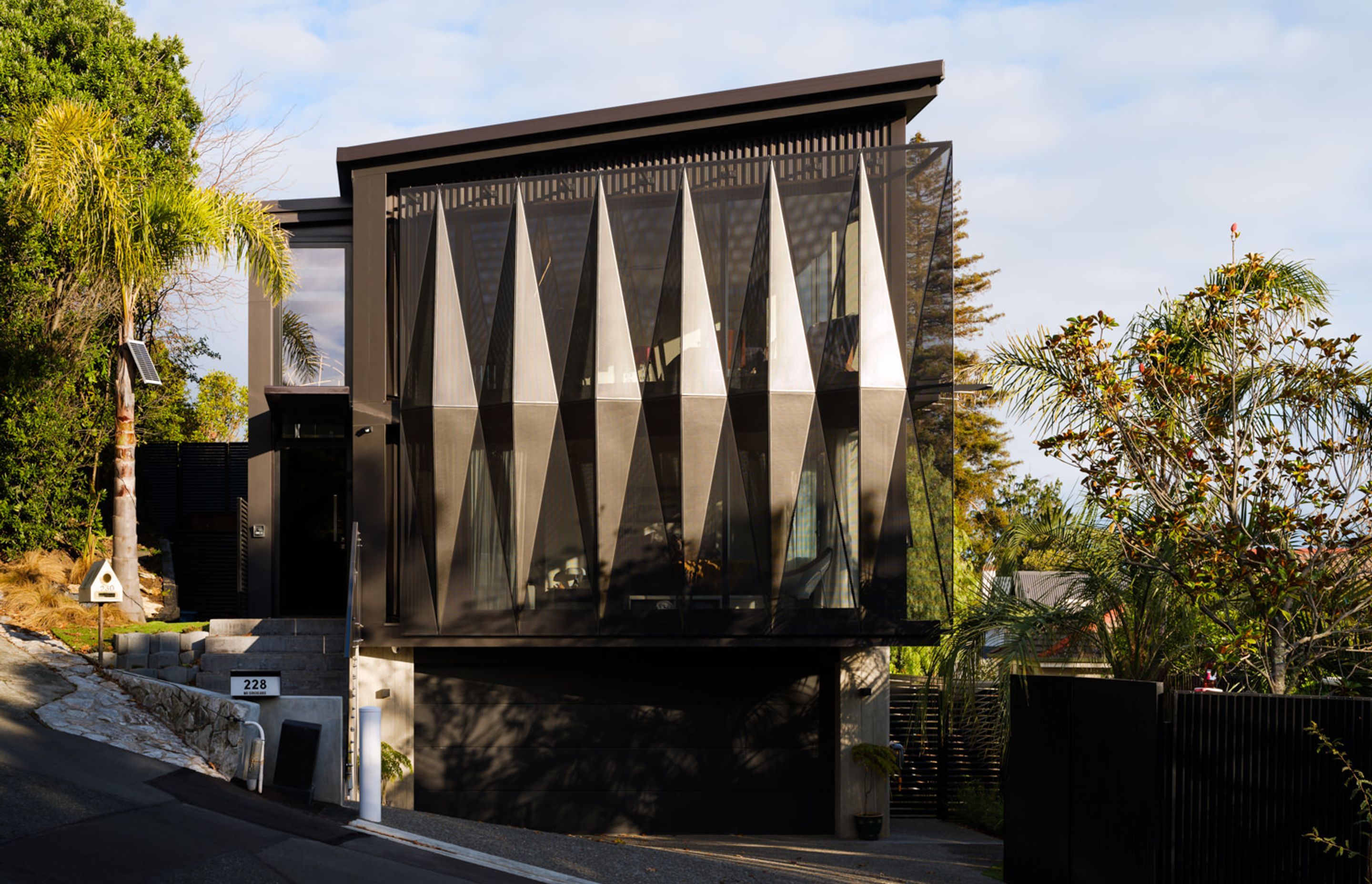 Situated over three levels, this house maximises its 331m2 site as well as the views out across the city towards Port Nelson and Te Tai-o-Aoere/Tasman Bay.