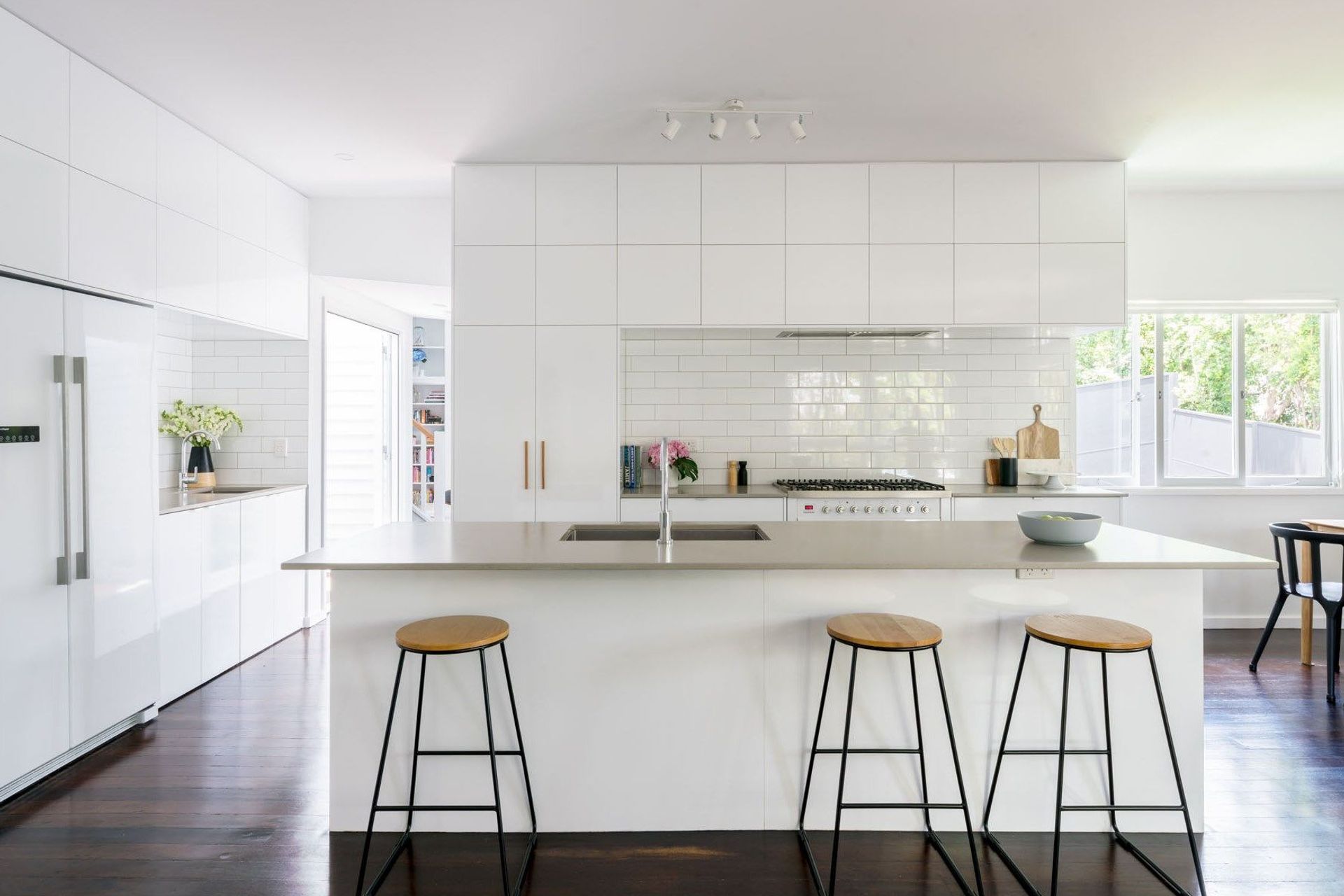 The kitchen is opened up to the living and dining as the main family gathering space, and a 'secret' laundry is subtly integrated into the space. Natural light and ventilation are prioritised.