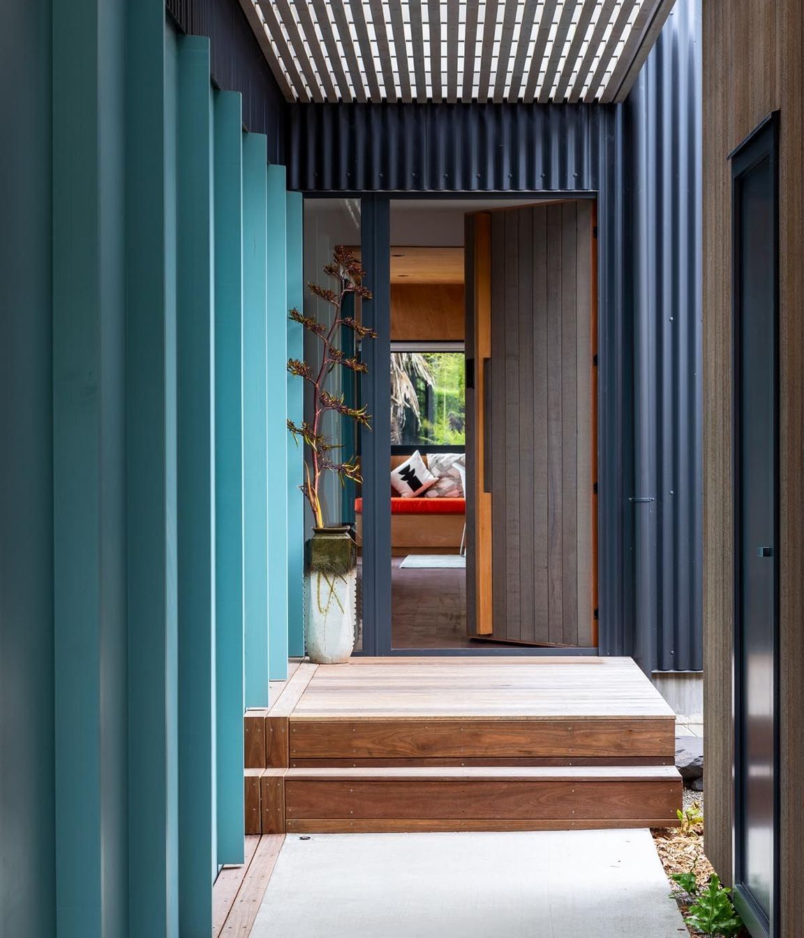 The boardwalk approach to the main front door passes underneath the upstairs apartment. There is a courtyard next to the front door. “As you walk down the restrained boardwalk, there is a sense of release as you get to the courtyard and go in the front door,” says Gerald.