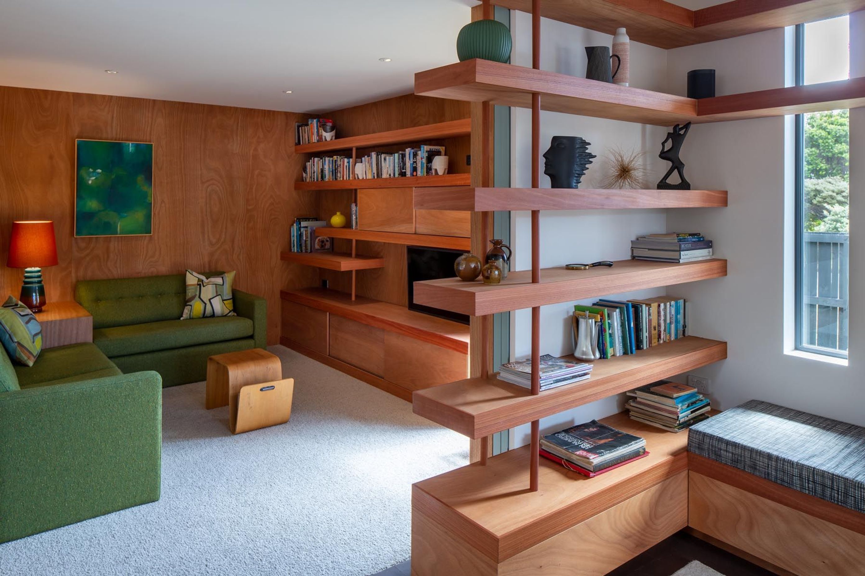 The blue doors slide away to open the den to the lounge. “That flexible room was quite important, a room that they could close down to watch TV or be part of the living main living space.” The house also has a study/workroom.