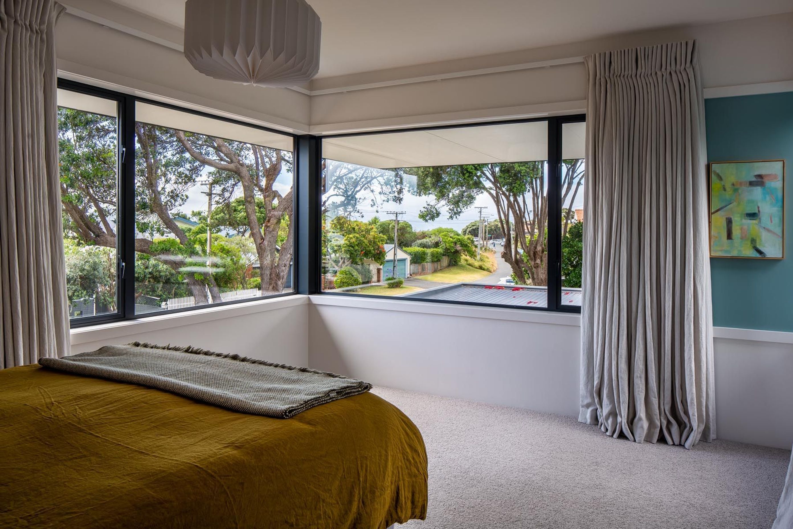 An existing pōhutukawa tree is on the corner of the property. “The master bedroom looks through the pōhutukawa tree out to the street, which is quite pretty.”