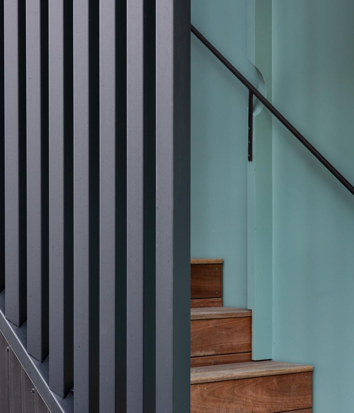 “We used the battens on the stairwell wall to run the handrail through small circular cutouts. The idea just popped out of my head at one point. It can be tricky to know how to do your brackets for the handrails.”