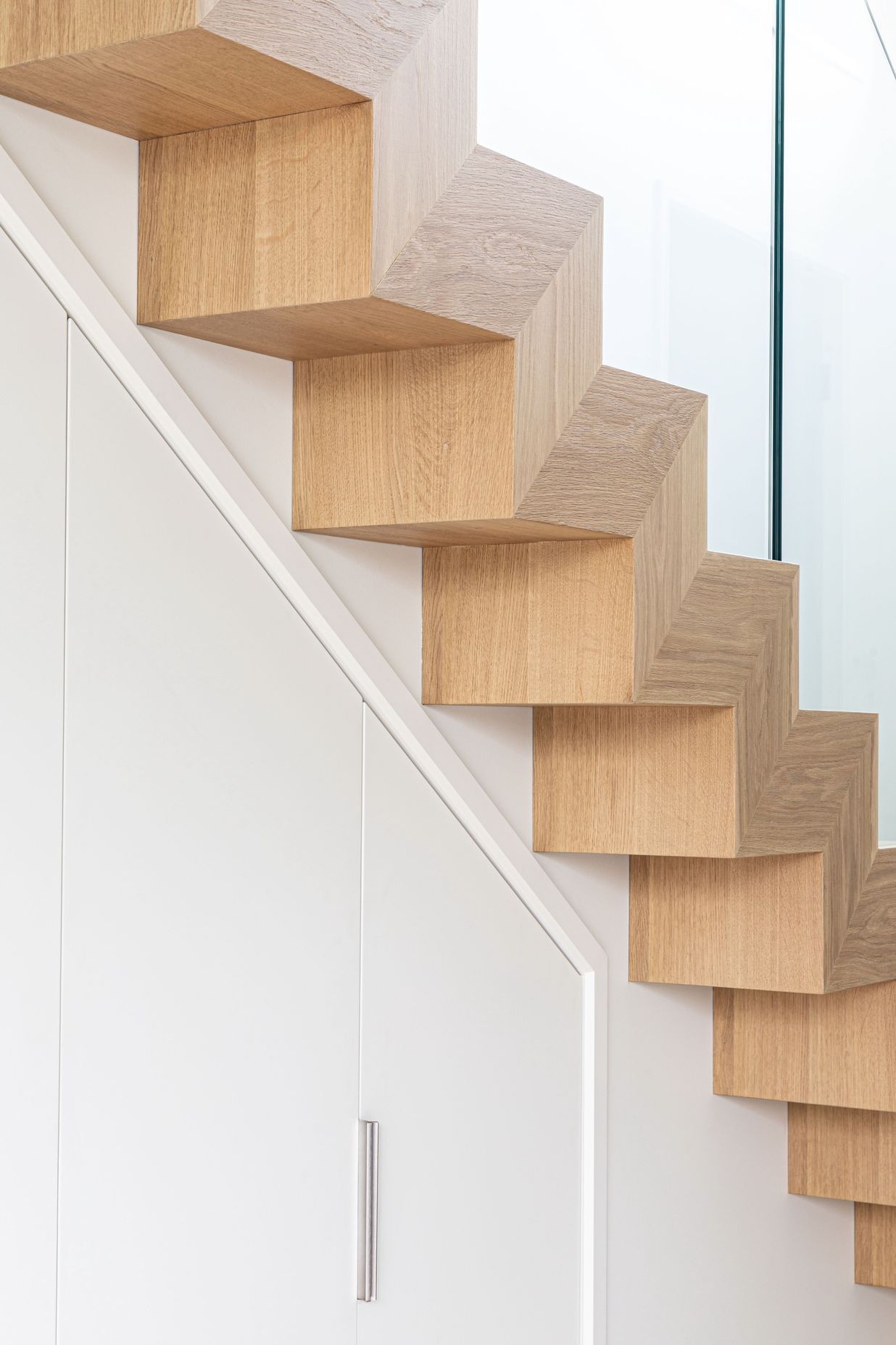 The geometric detailing of the stair has a strong sculptural quality.