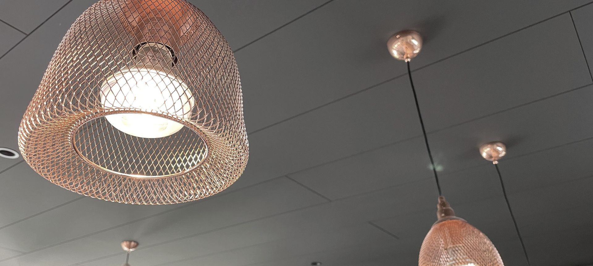 A bold black ceiling with Triboard TGV banner