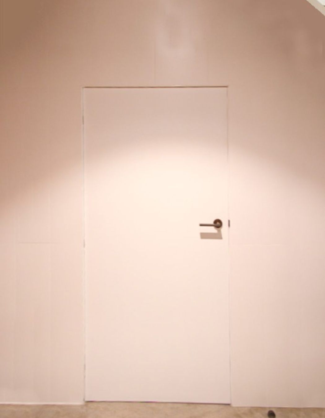 A custom-sized storage door under the central staircase.