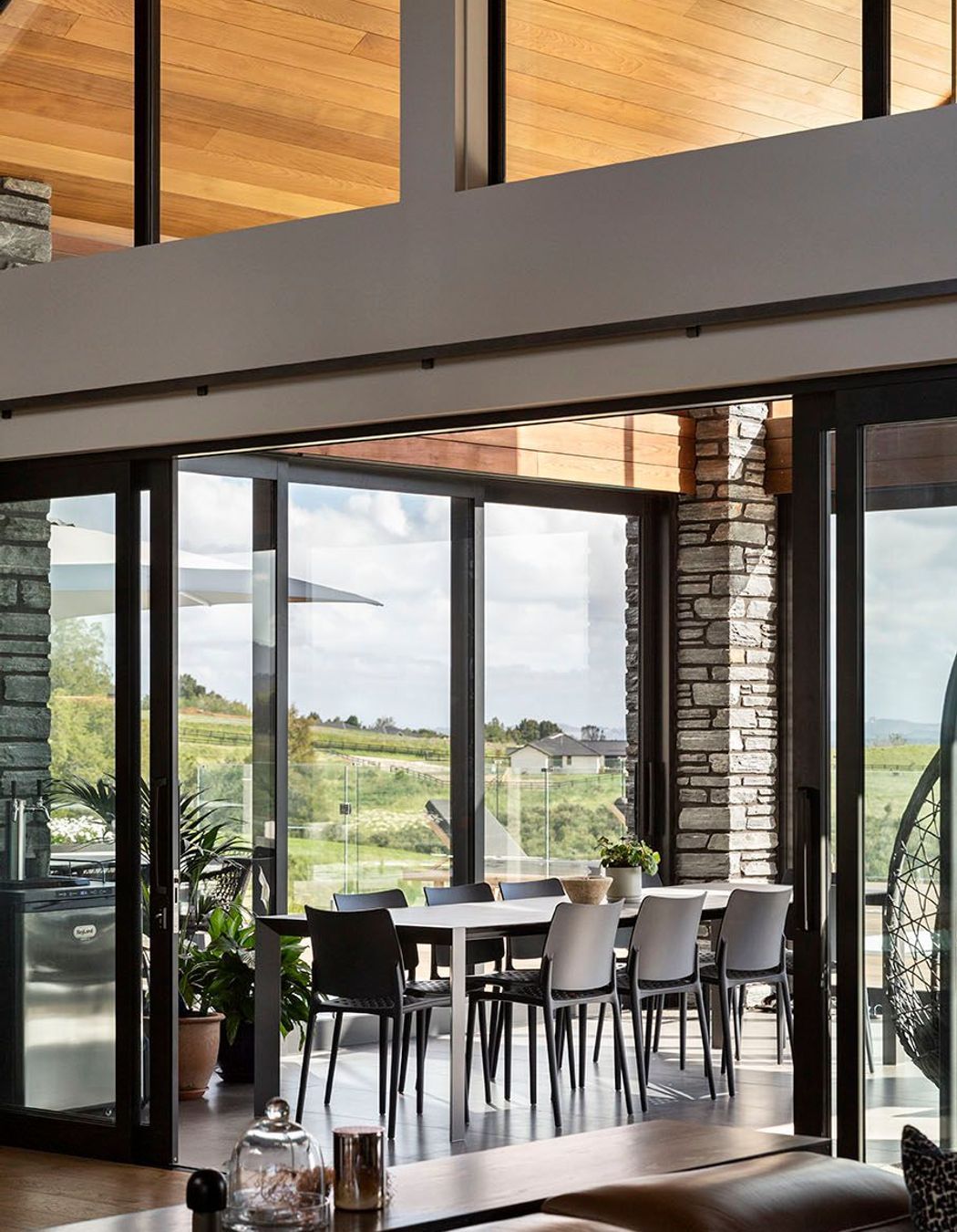 Schist cladding contrasts with the cedar panelling in the conservatory.