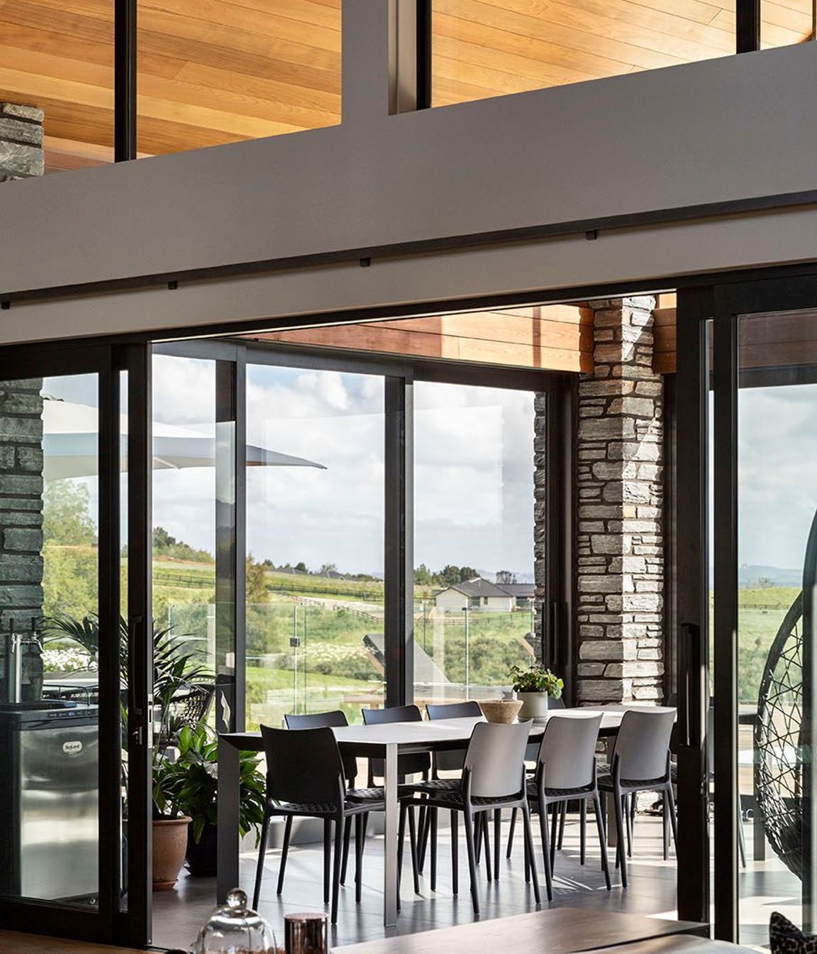 Schist cladding contrasts with the cedar panelling in the conservatory.