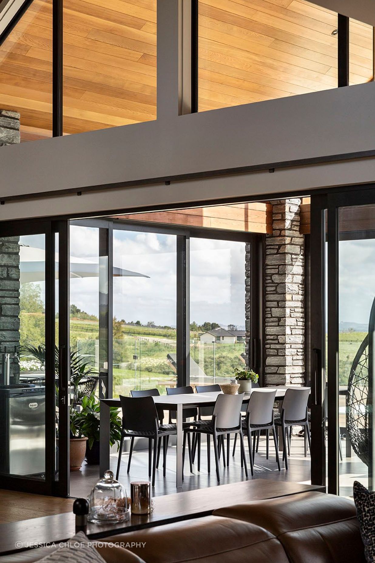 Schist cladding contrasts with the cedar panelling in the conservatory.