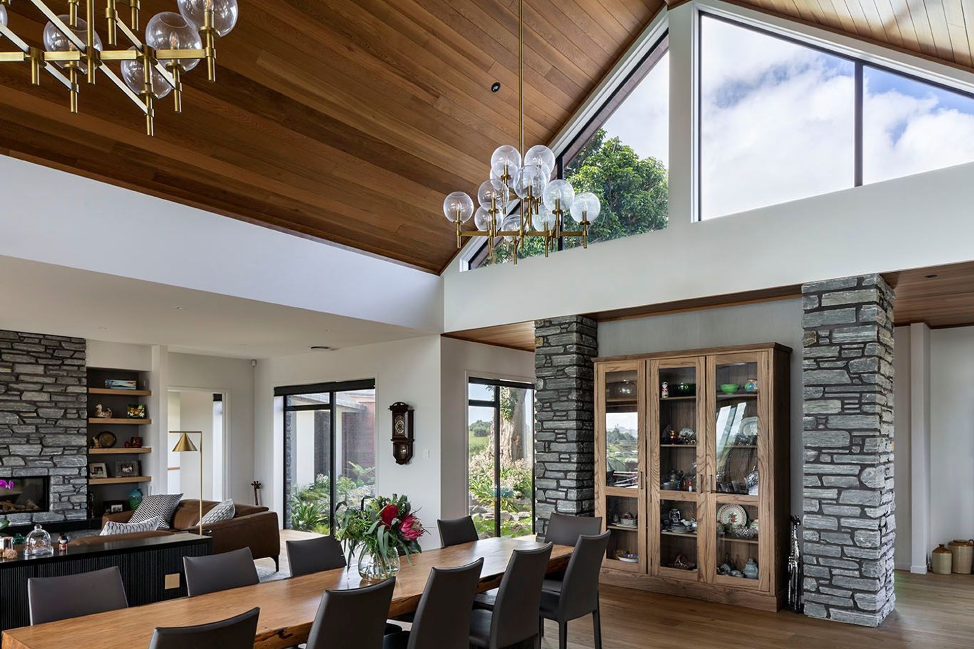 View from the kitchen island via the vaulted ceiling to the puriri tree at the entry.