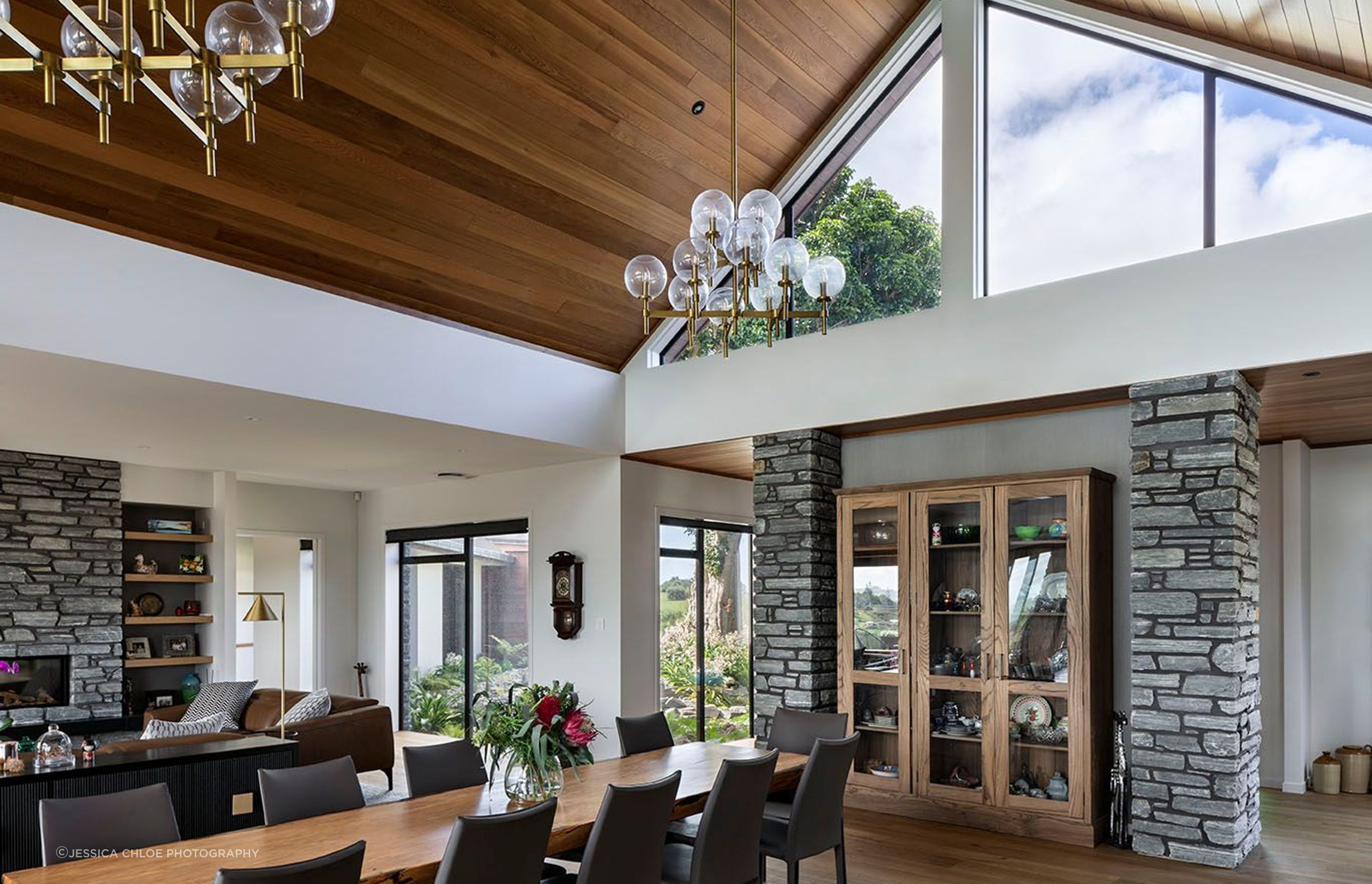 View from the kitchen island via the vaulted ceiling to the puriri tree at the entry.