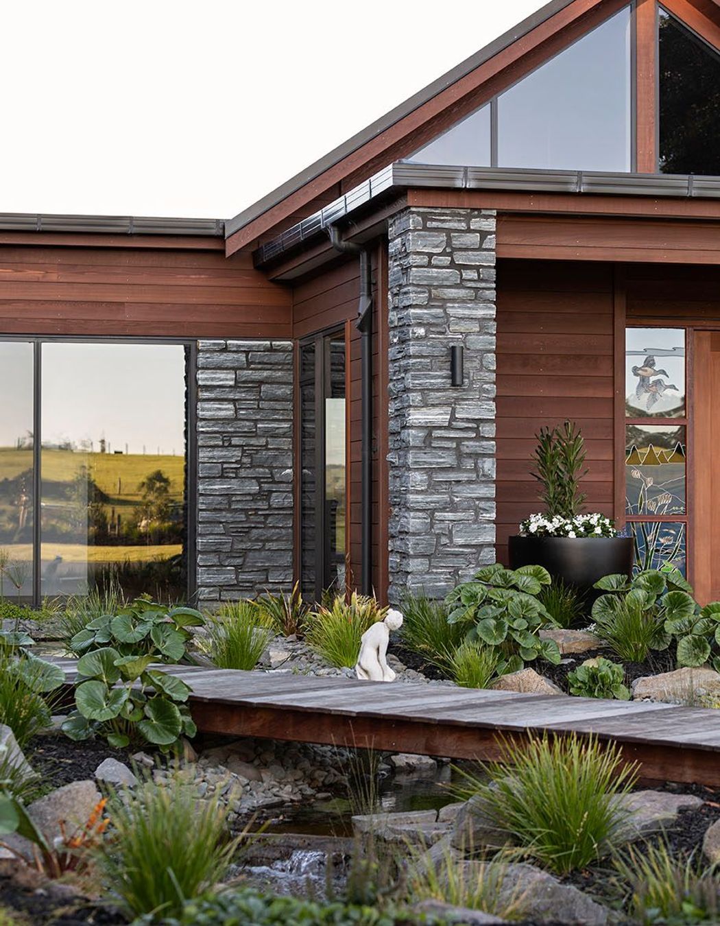 Horizontal Cedar weatherboard and schist cladding are combined for an effortless country home.