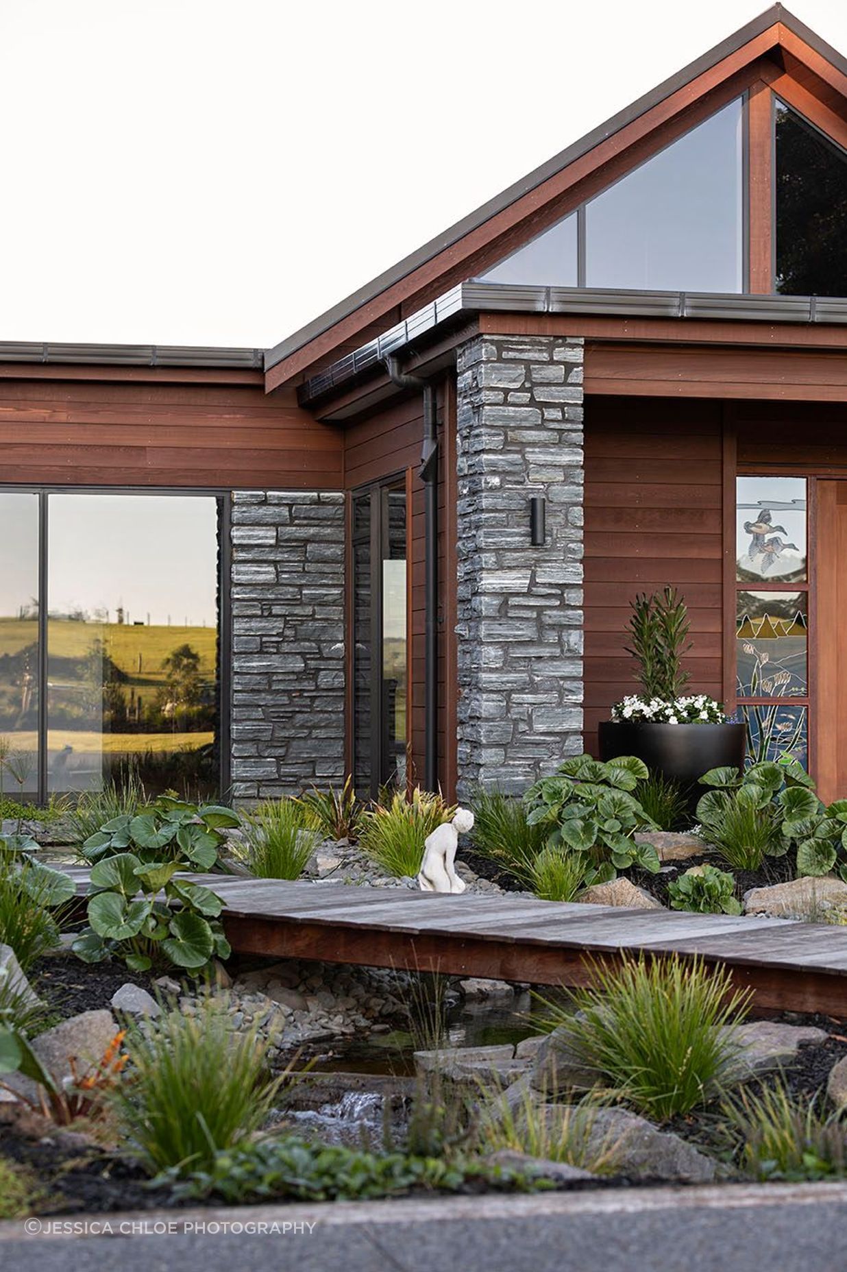 Horizontal Cedar weatherboard and schist cladding are combined for an effortless country home.